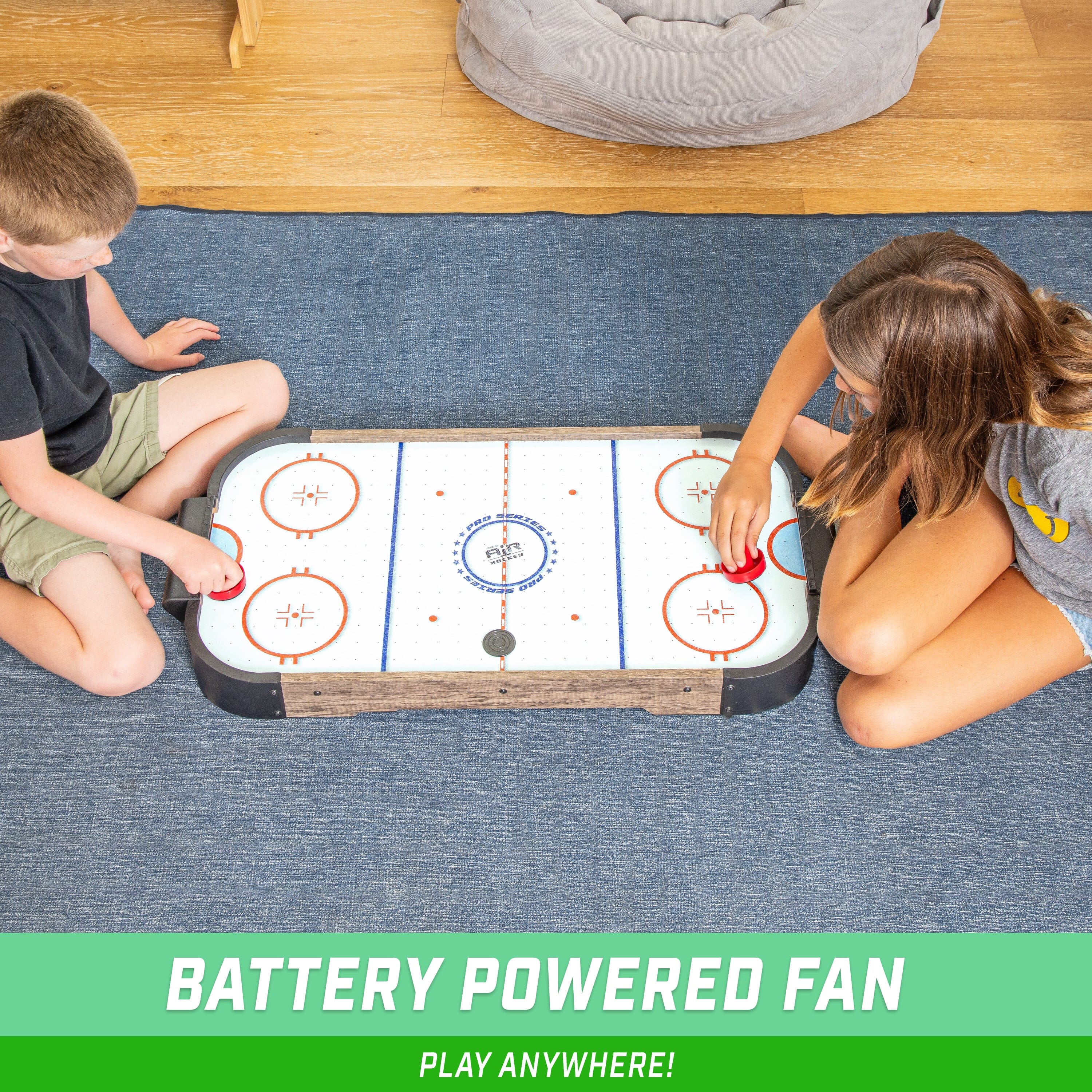 two children playing a game of air hockey