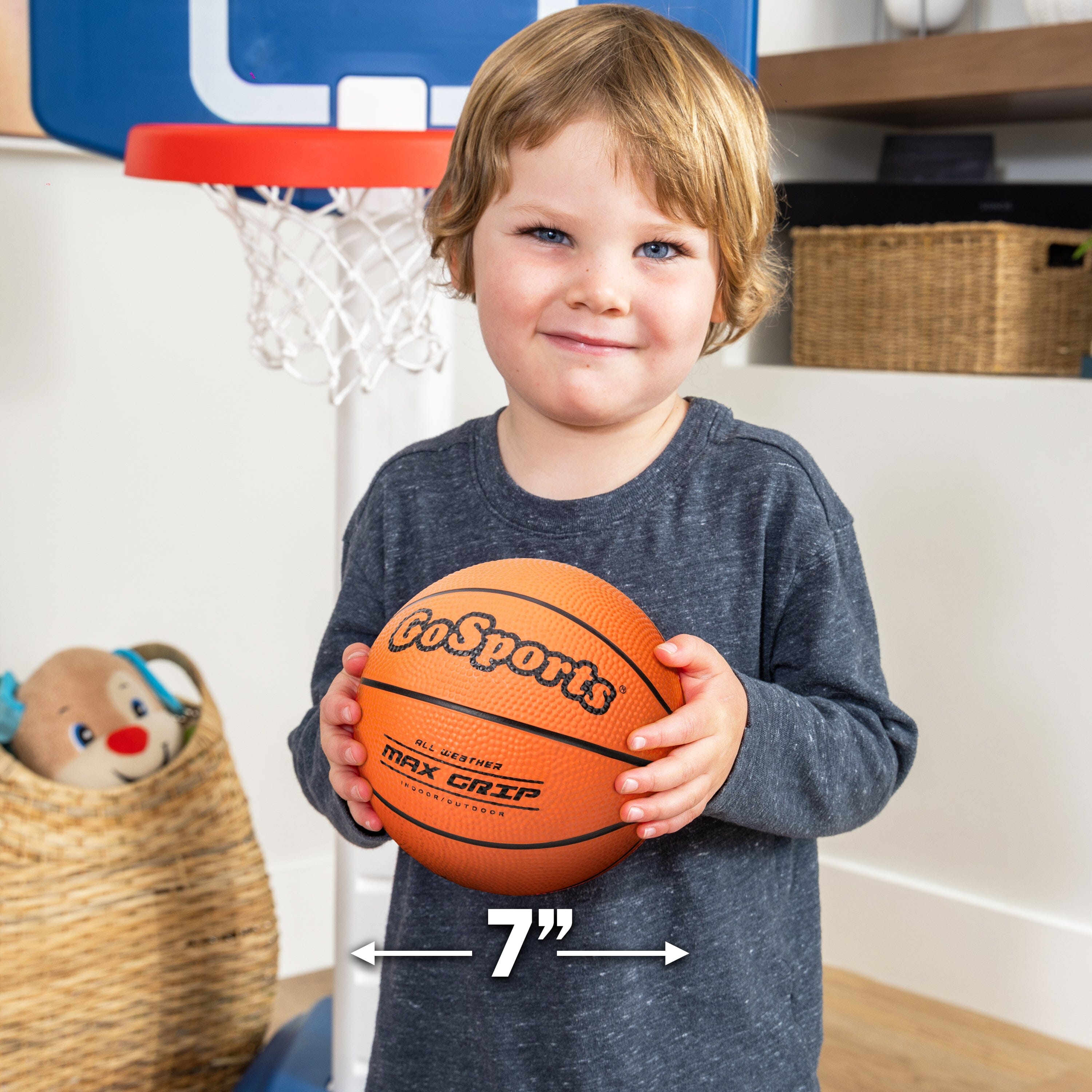 a young boy holding a basketball ball in his hands
