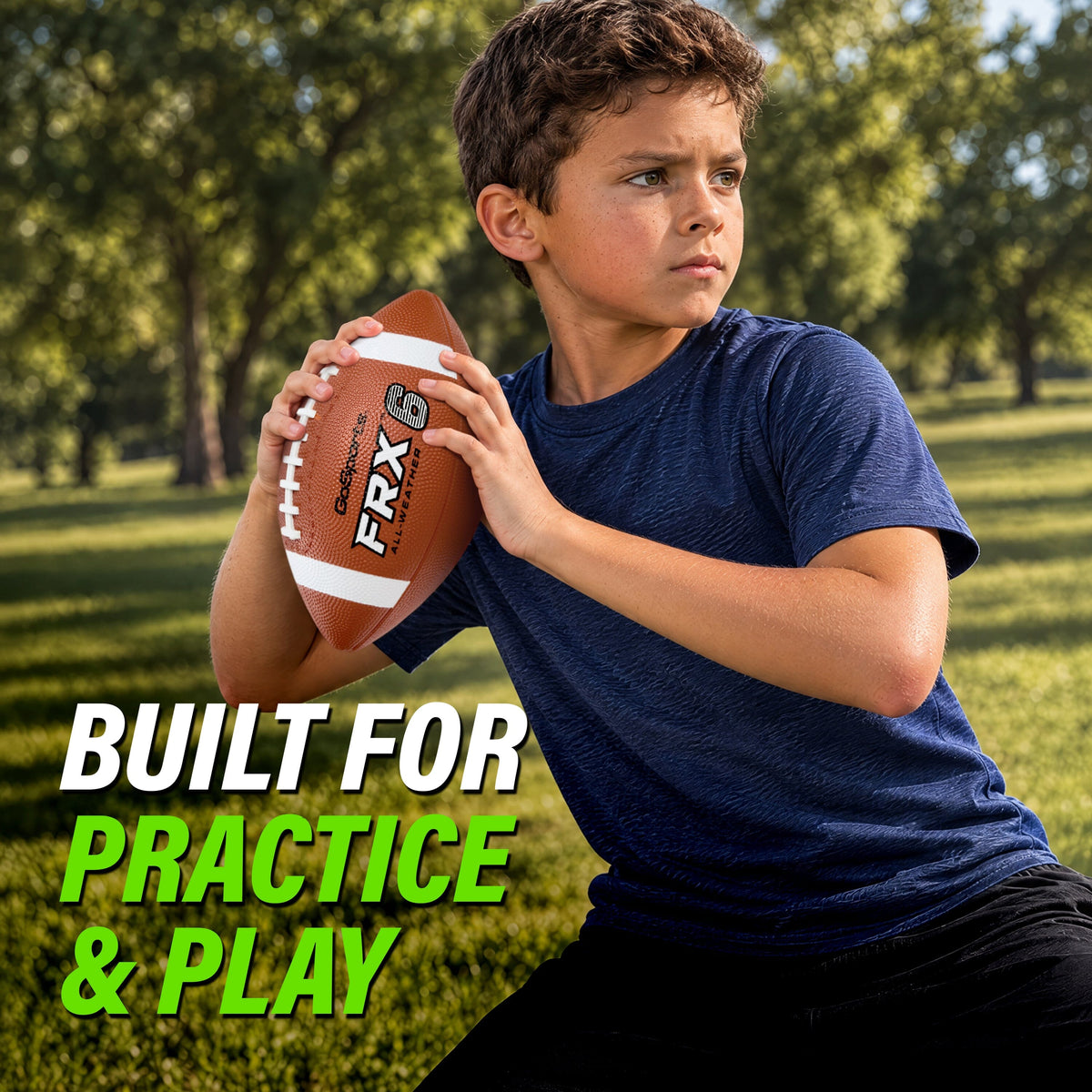 Boy in a blue t-shirt gripping a GoSports FRX 6 pee wee football, ready to throw in a park
