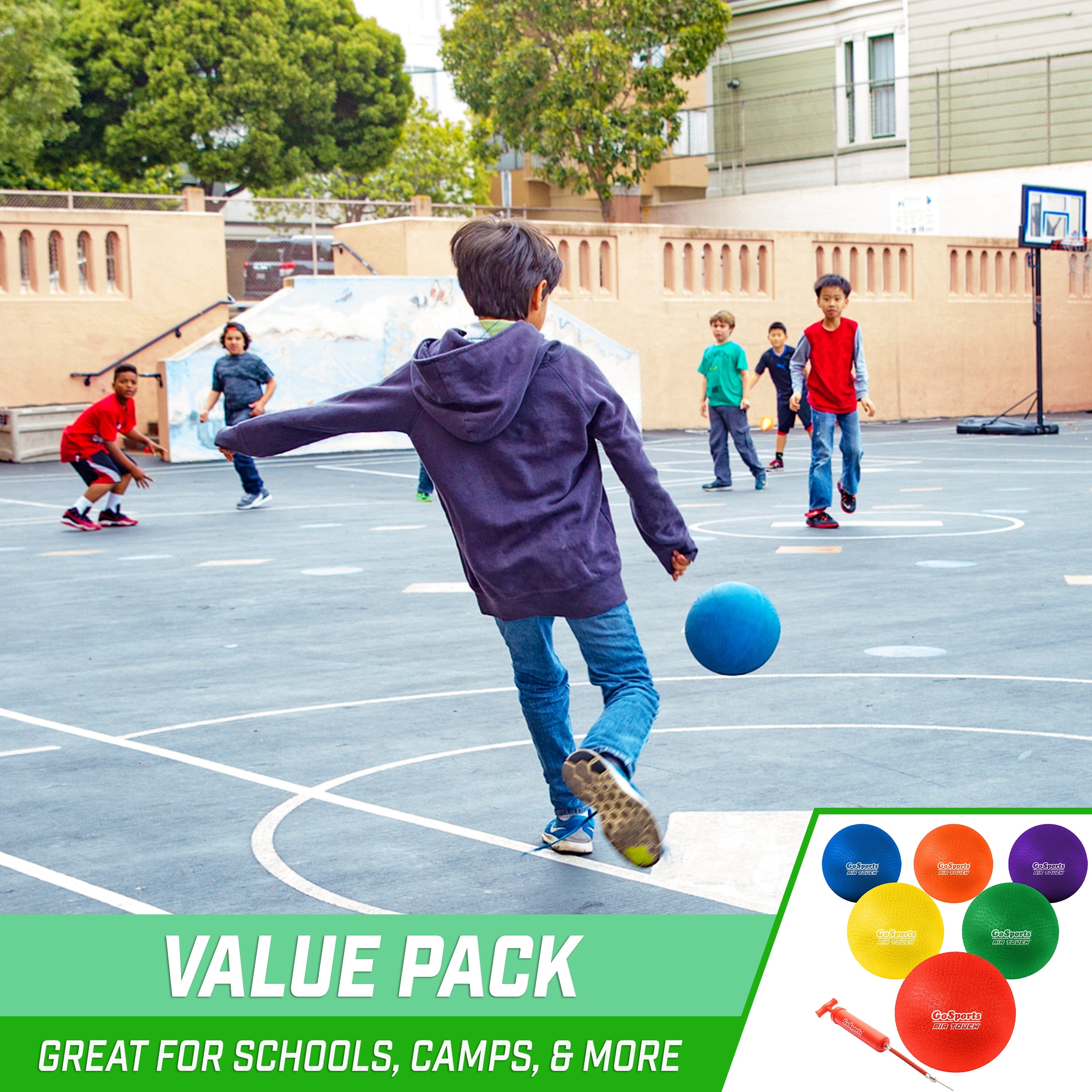 a group of kids playing basketball in a parking lot