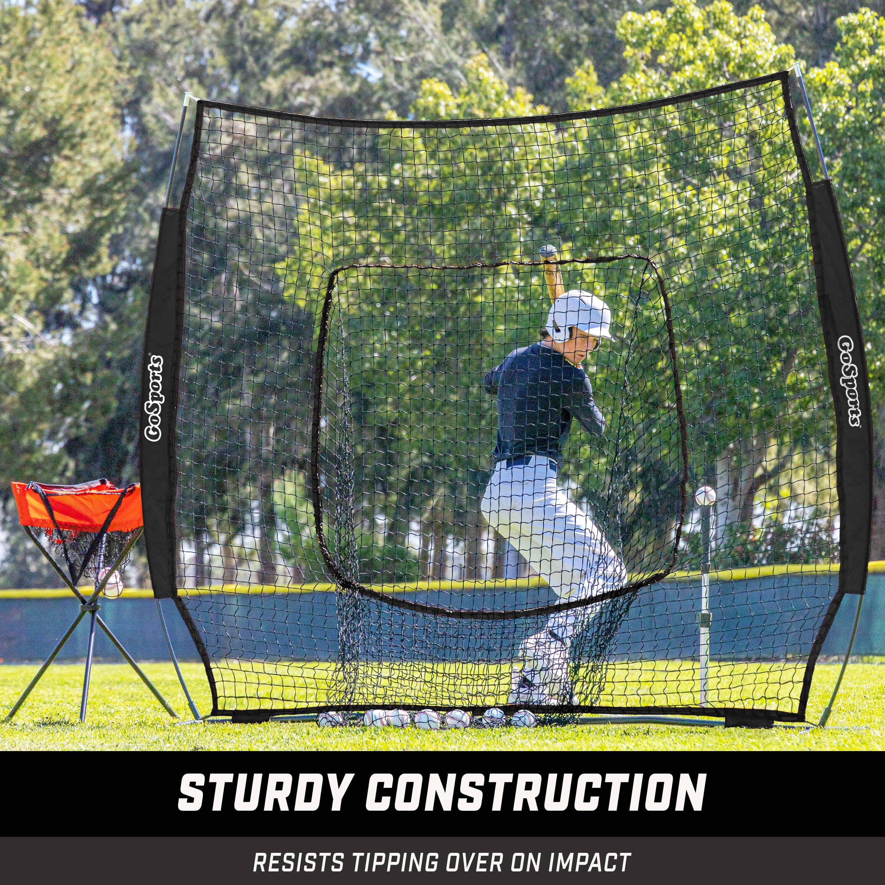 a baseball batting net with a baseball player in the background