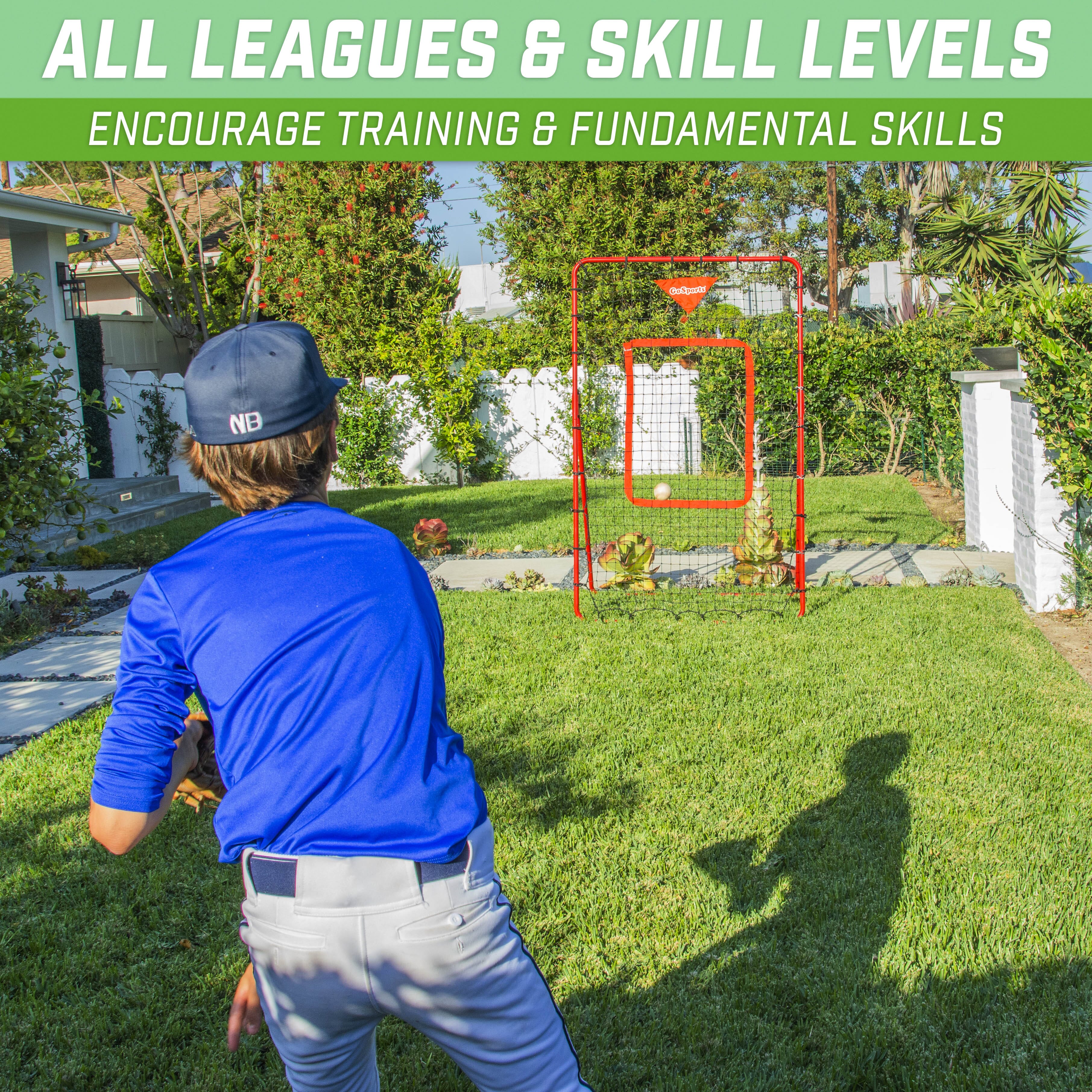 a boy playing baseball in the yard with a ball