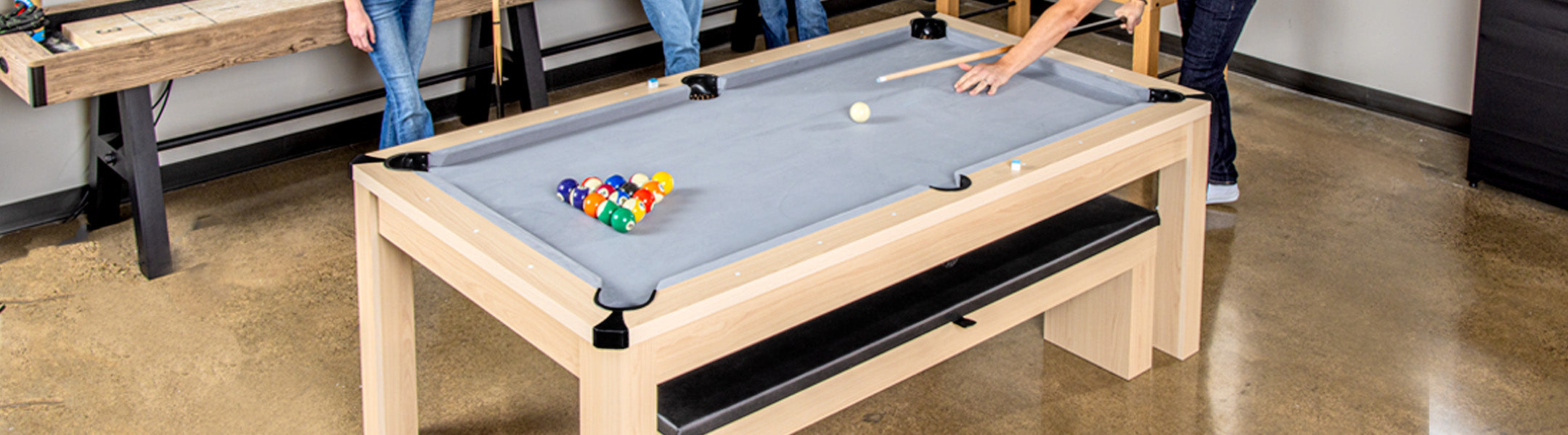 Pool table with colorful balls and pool cues in a casual setting