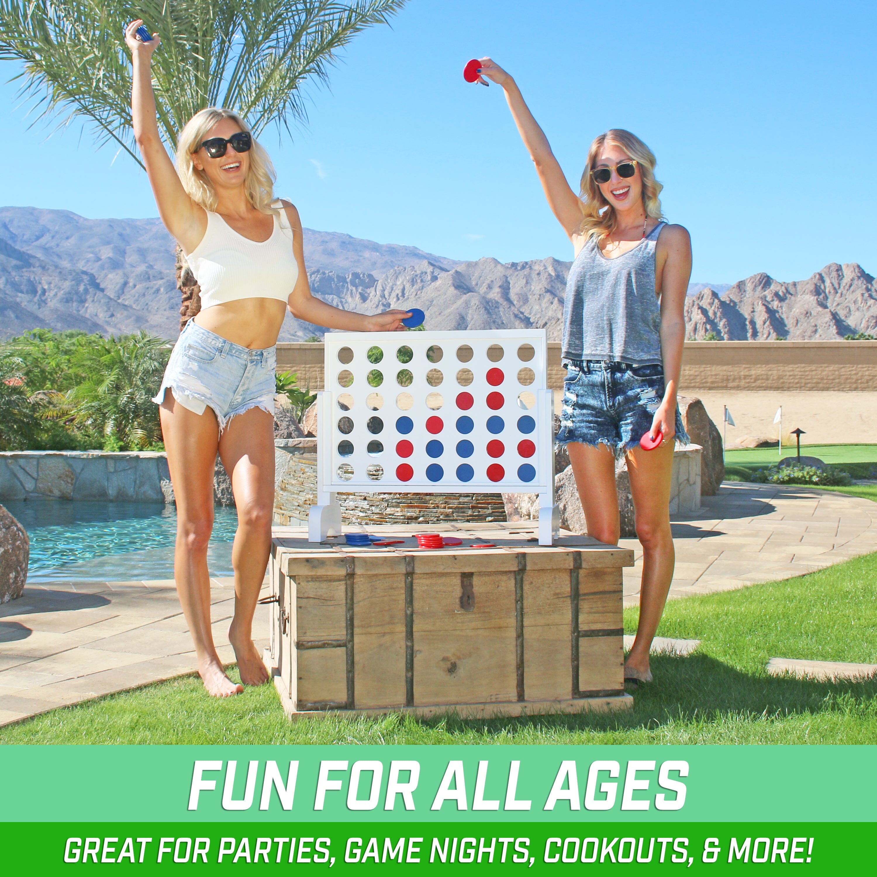 two girls playing giant checkers in a backyard pool