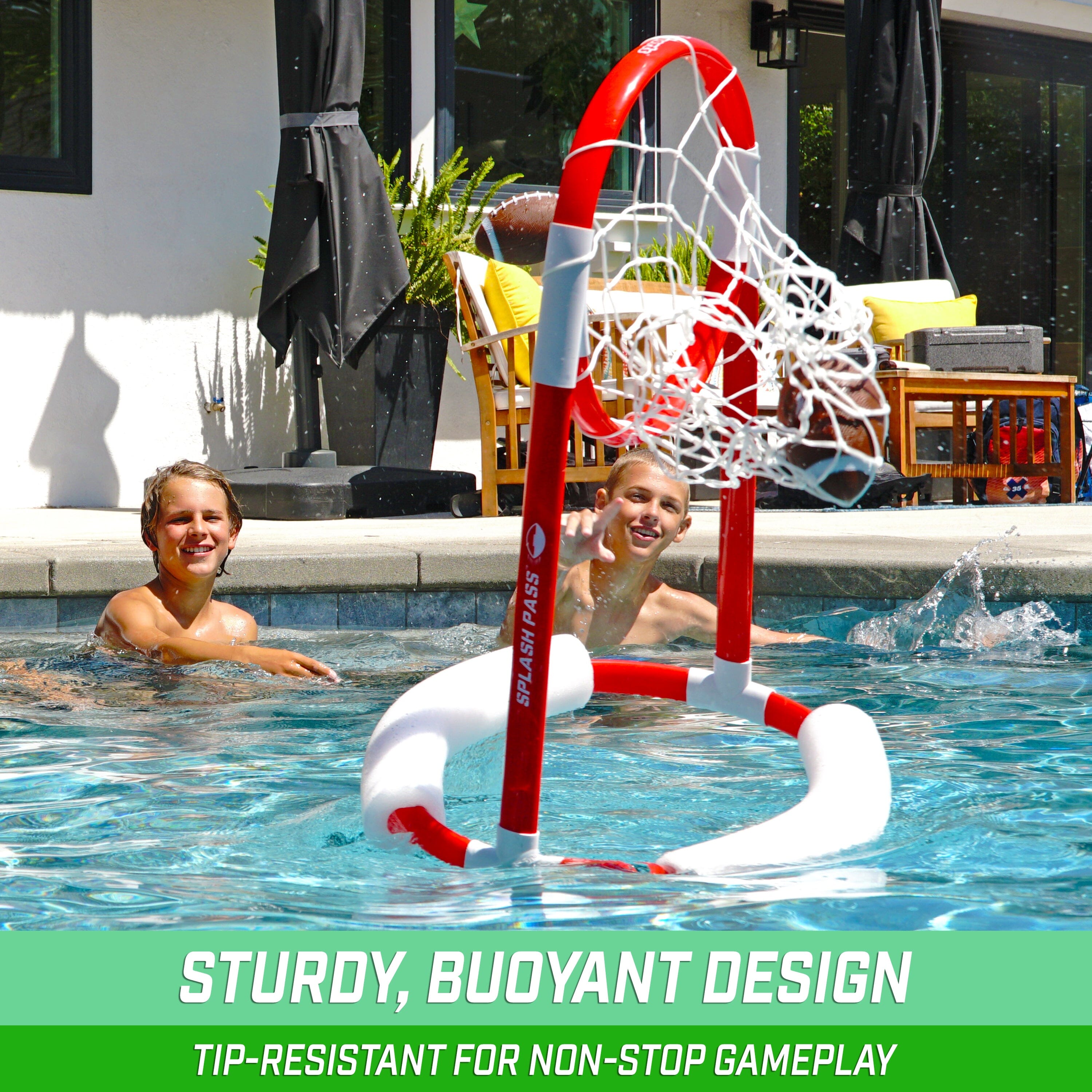 a boy playing basketball in a pool with a basketball hoop