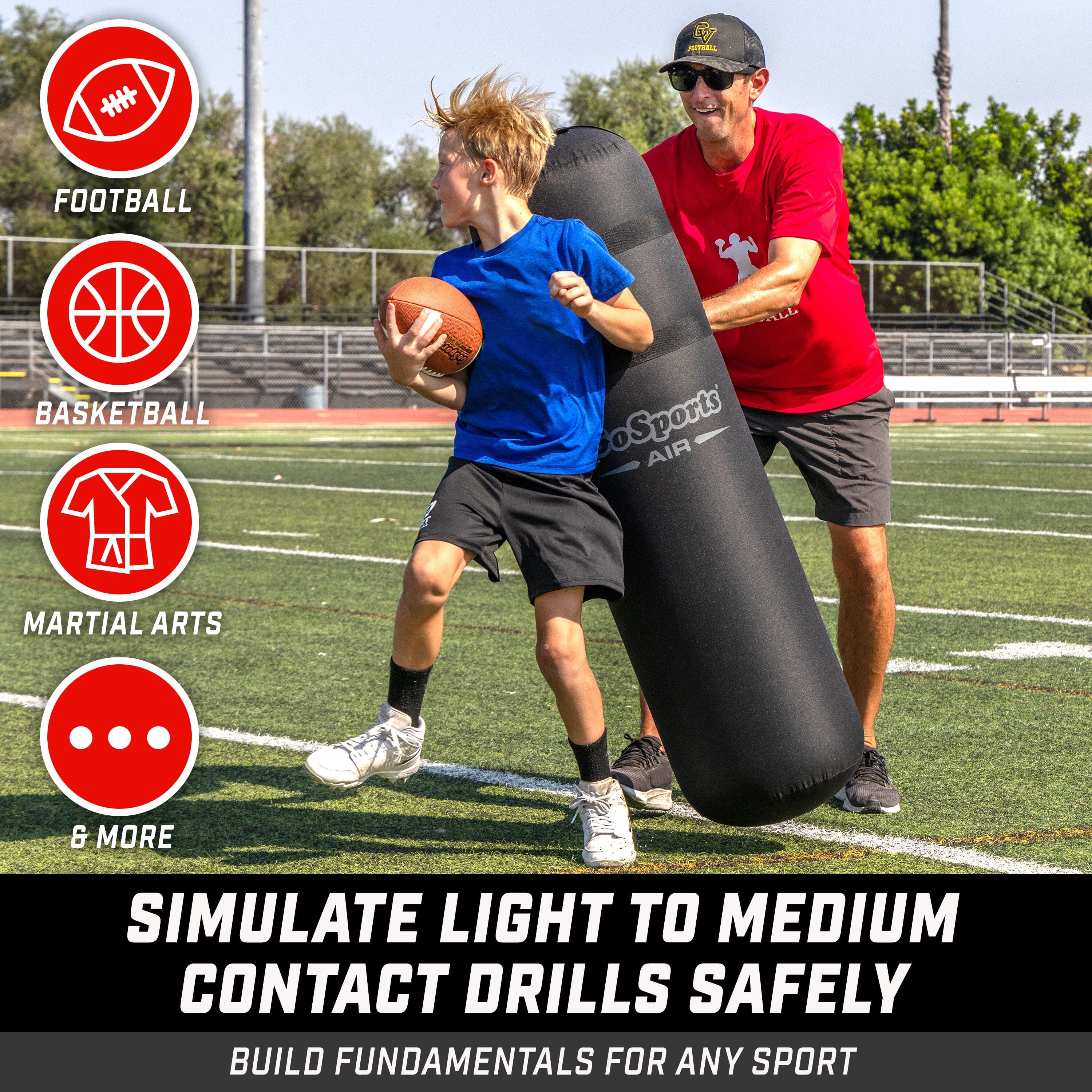 child holding football while avoiding black inflatable being held by man