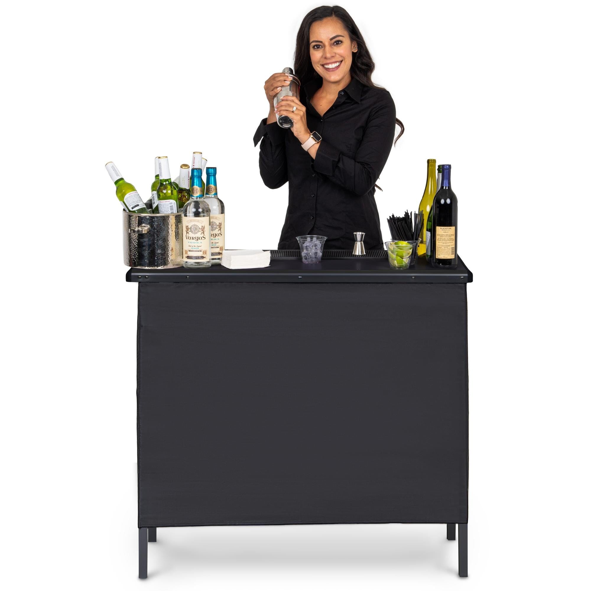 a woman standing behind a bar with bottles of wine