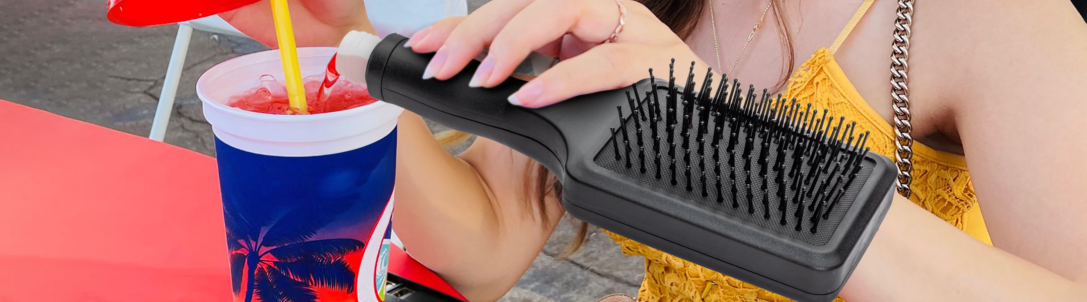 Person pouring liquid into a cup from a black hairbrush