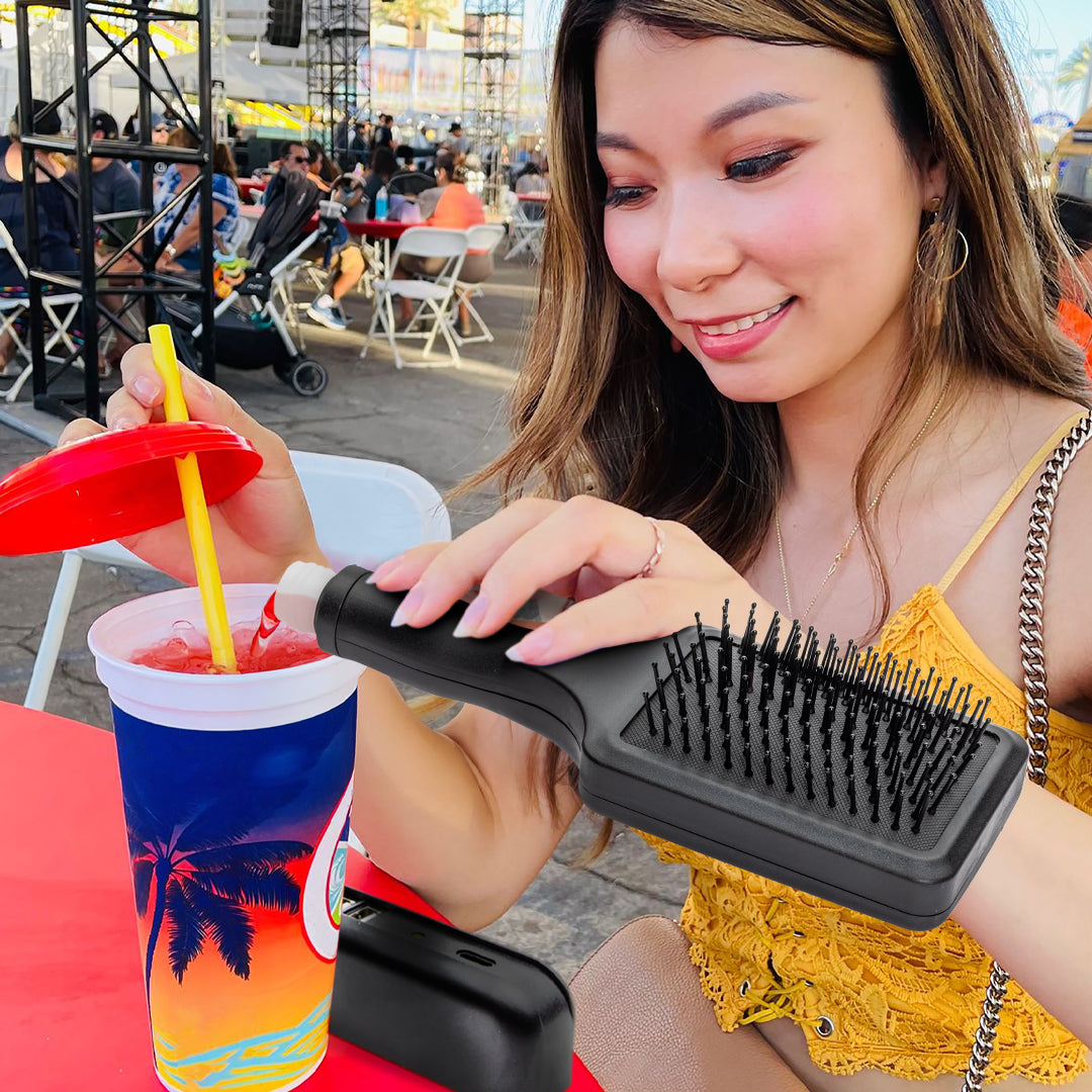 Woman pouring liquid from a black hairbrush into a blue white cup.