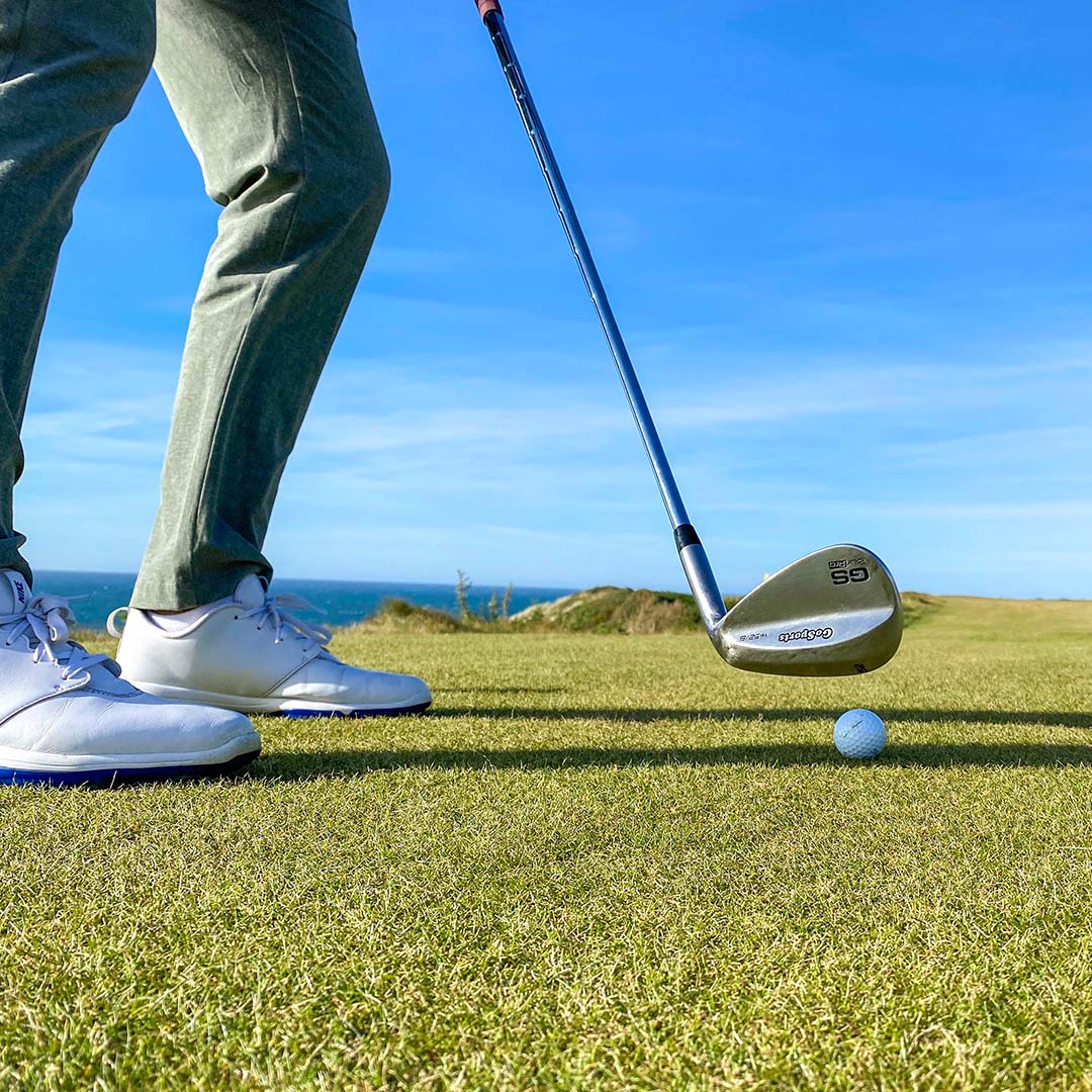 Golf swing on a golf course with ocean view