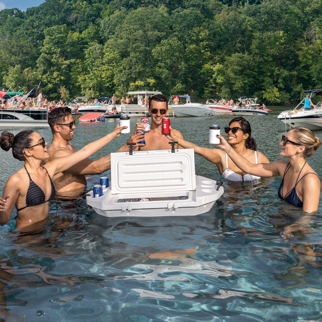 Group of people in a lake with a cooler box and drinks