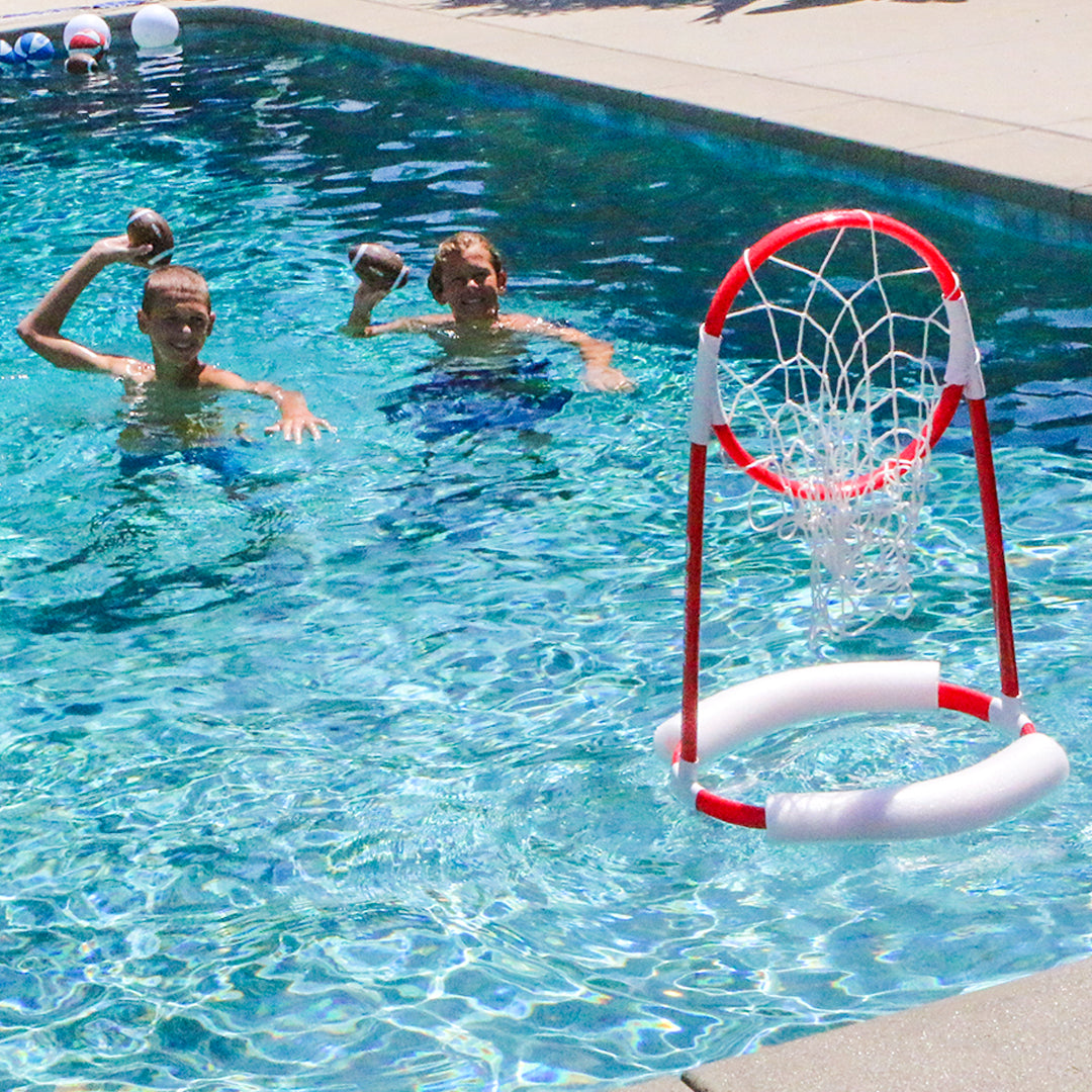 Two children playing with a pool red target hoop in a swimming pool.