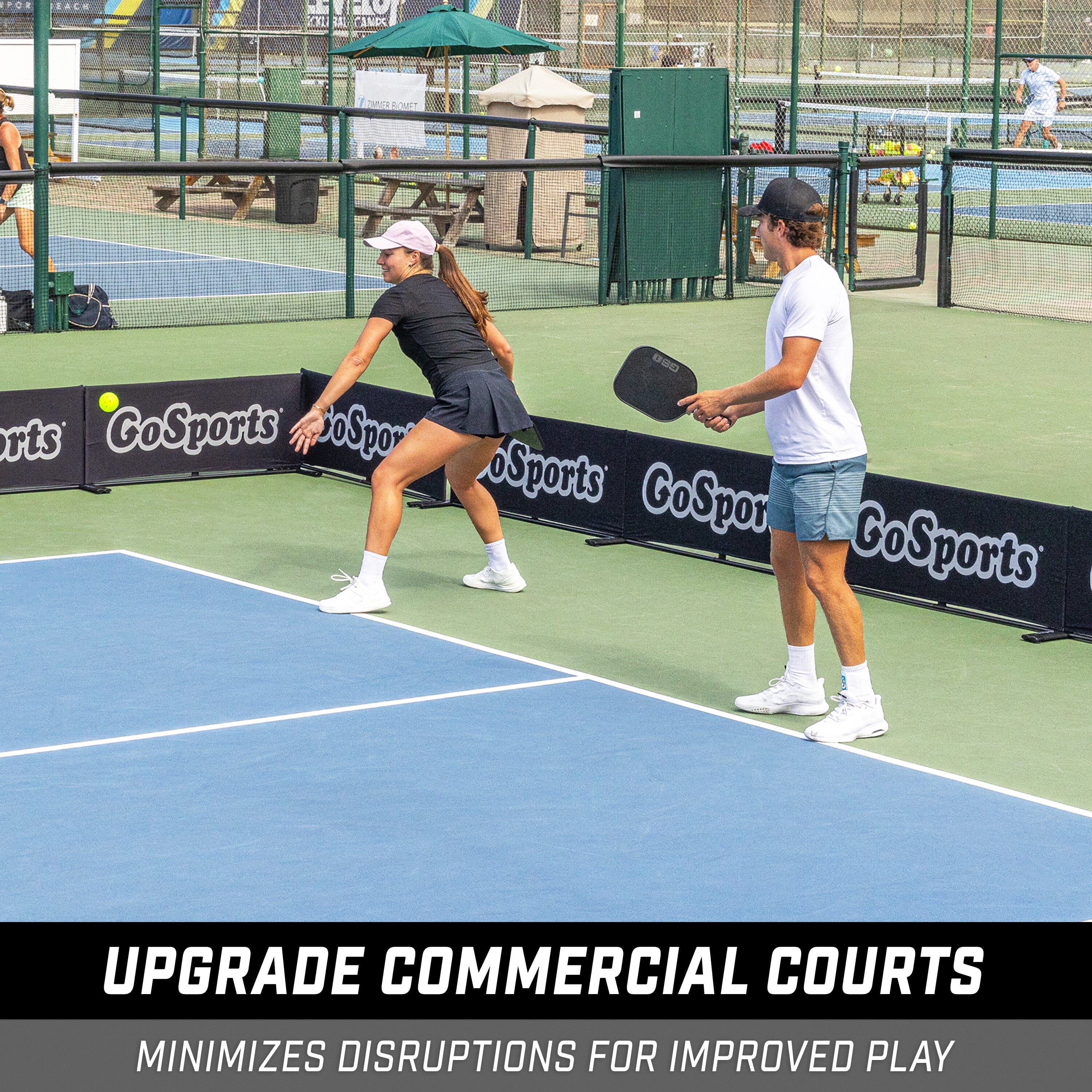 man and a woman playing pickleball on a tennis court