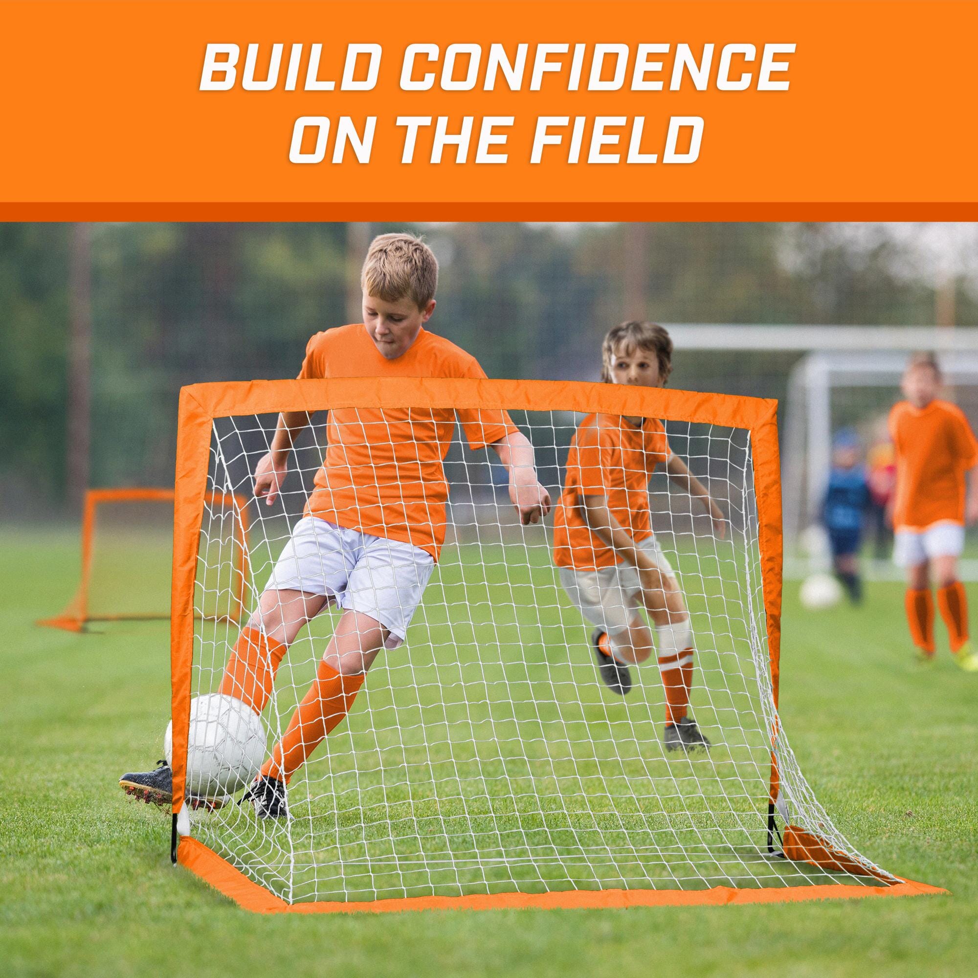 a group of young boys playing soccer on a field