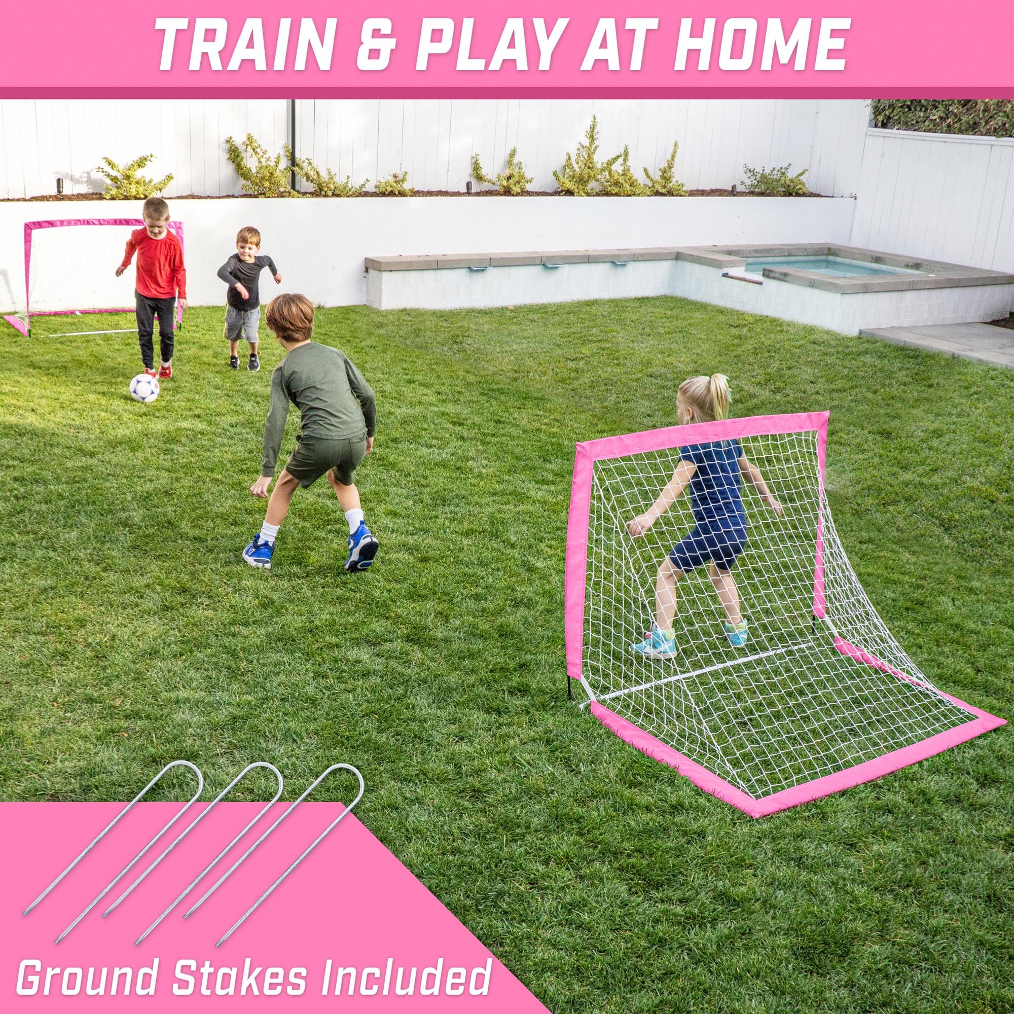 a backyard play area with a soccer goal and a pink soccer goal