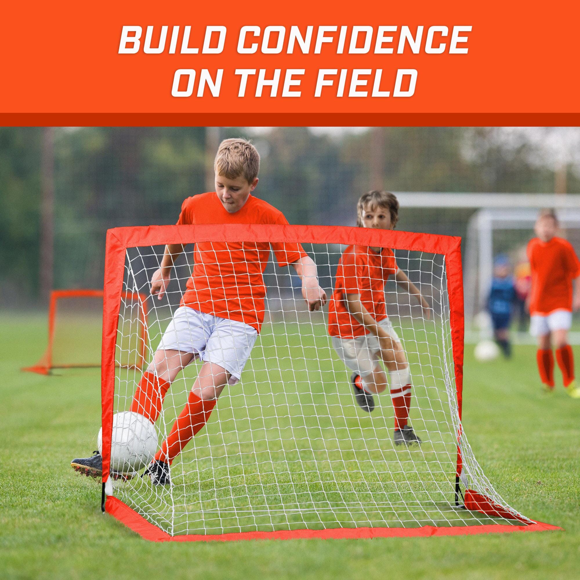 a group of young boys playing soccer on a field