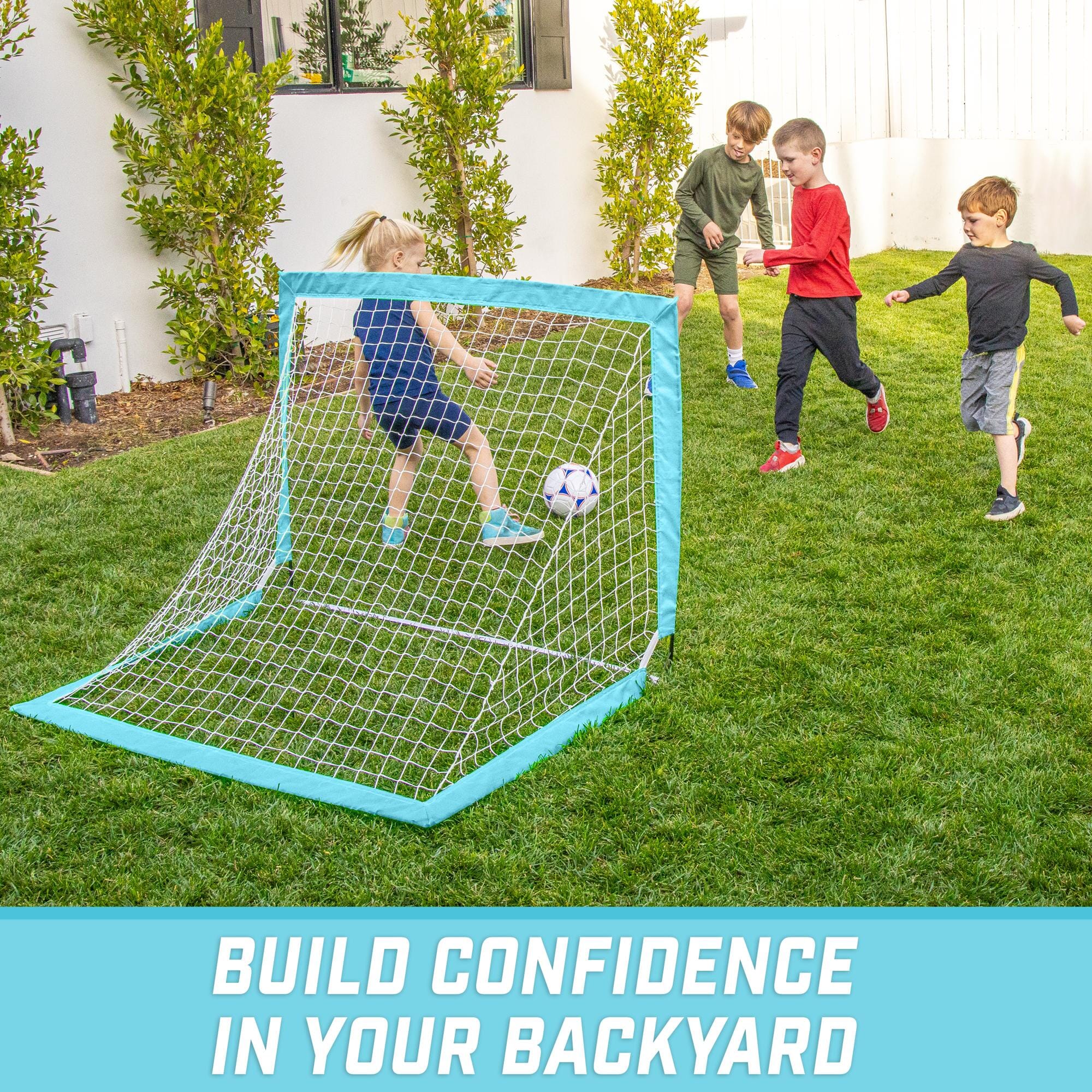 a backyard soccer goal with two kids playing in it