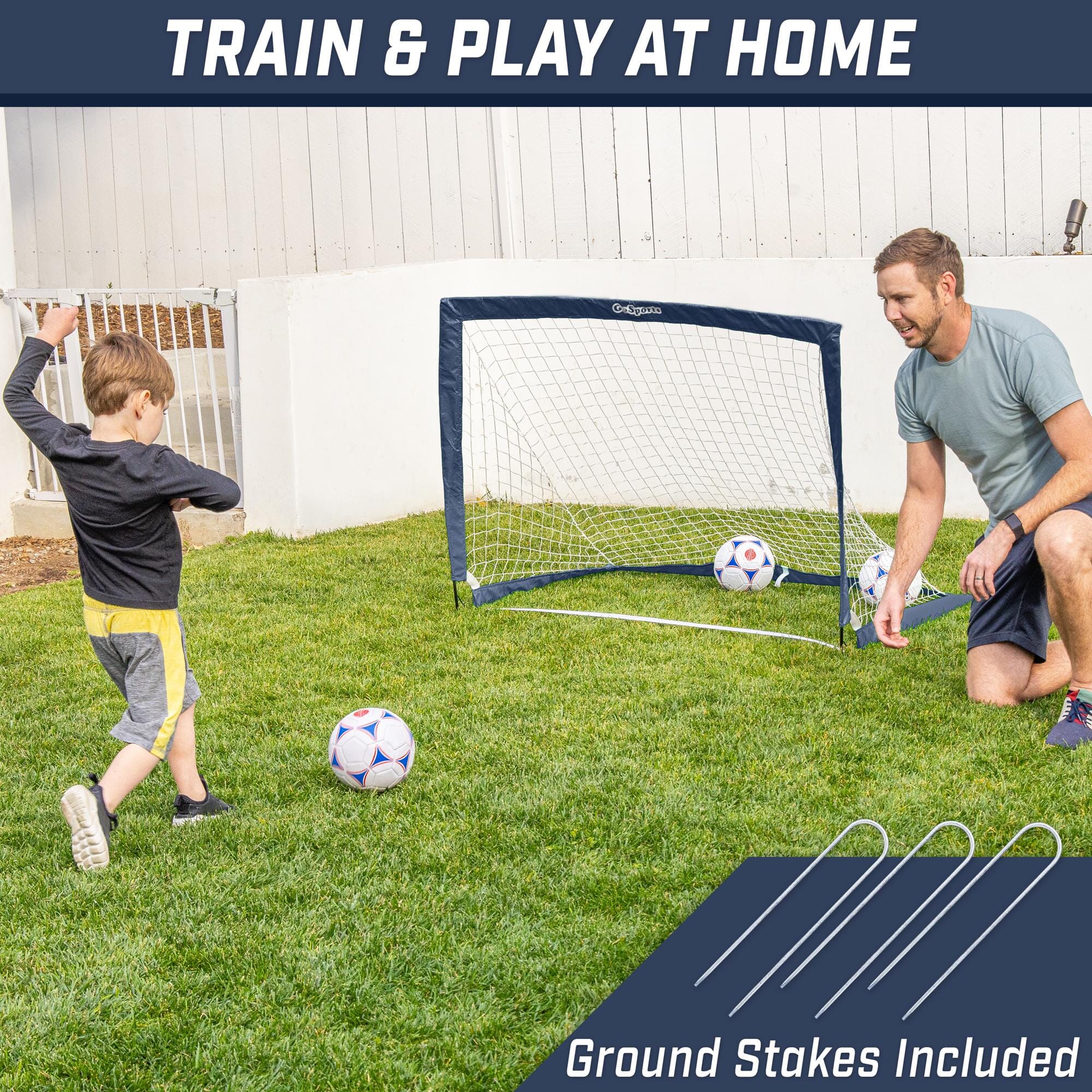 a man and a young boy playing soccer in the backyard