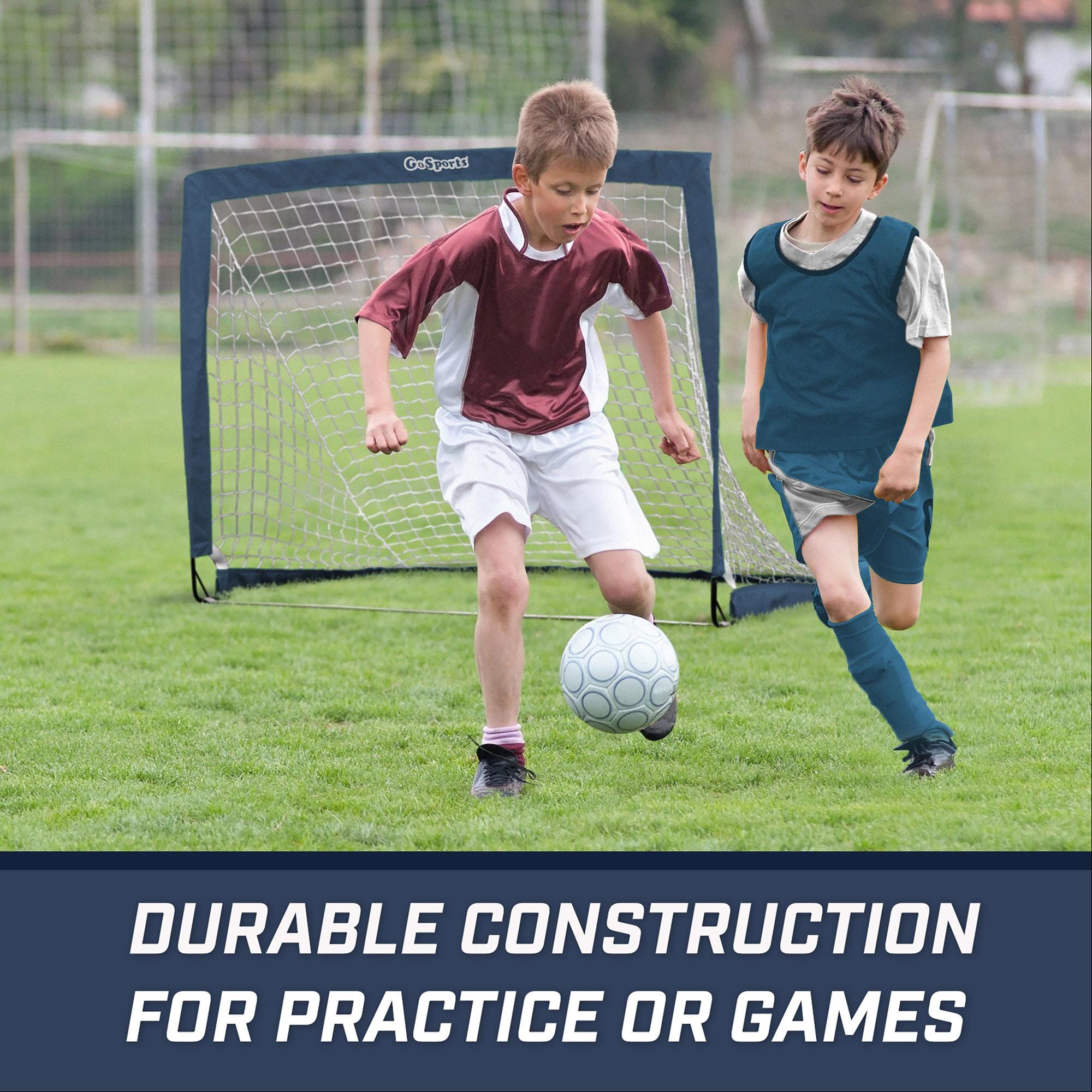 two boys playing soccer on a field with the words, durable construction for soccer games