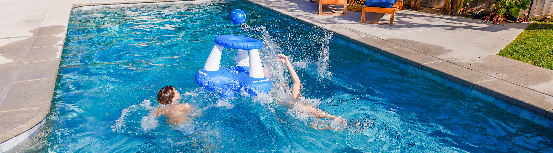 Two children playing in a pool with a blue inflatable toy.
