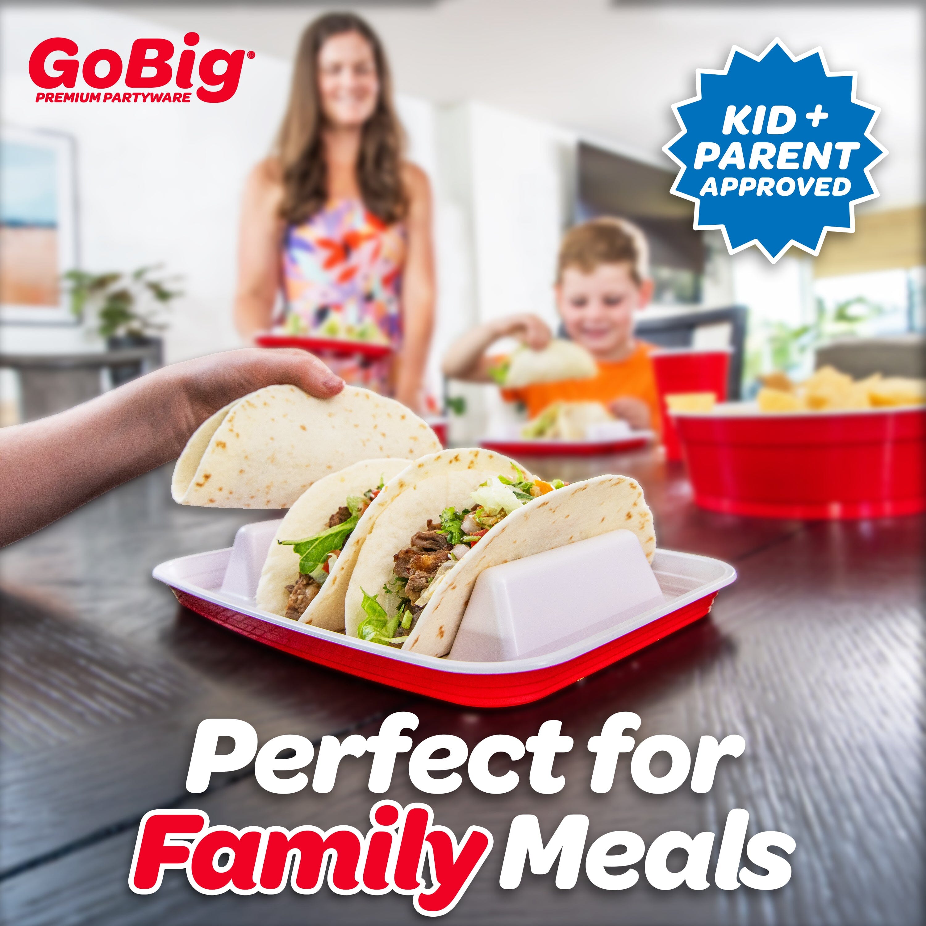 Tacos in a red and white container with a family in the background, featuring GoBig partyware branding.