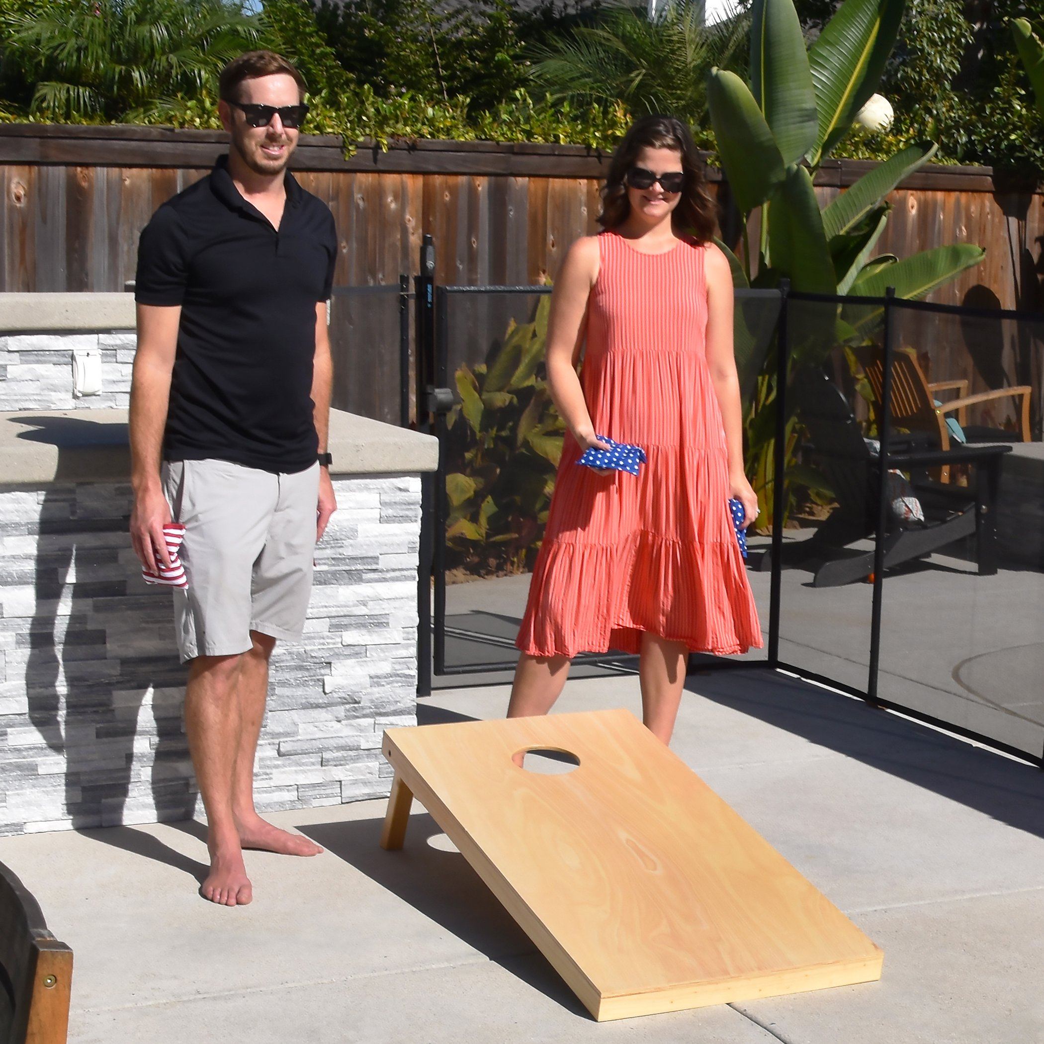 a man and woman playing a game of corn