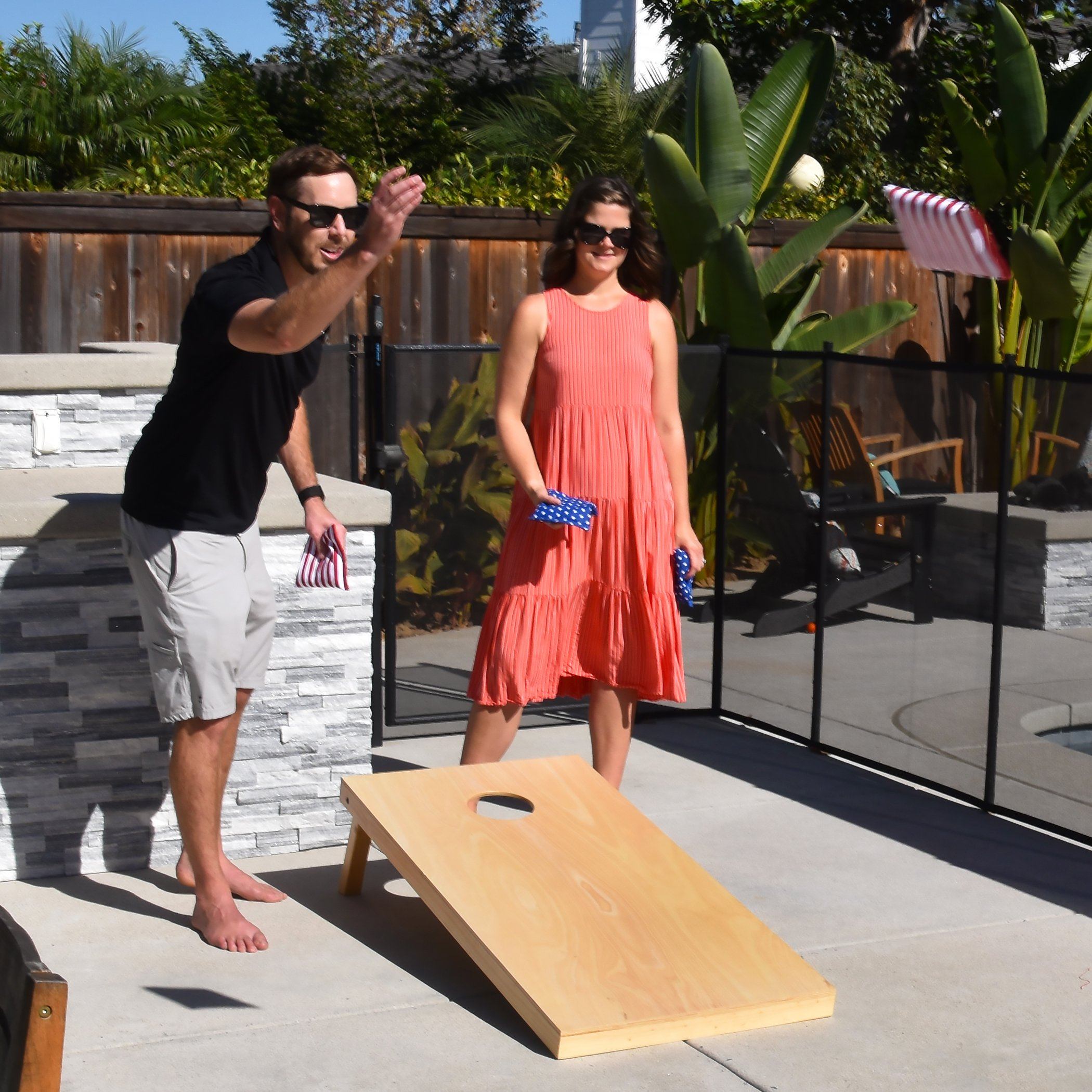 a man and woman playing a game of corn