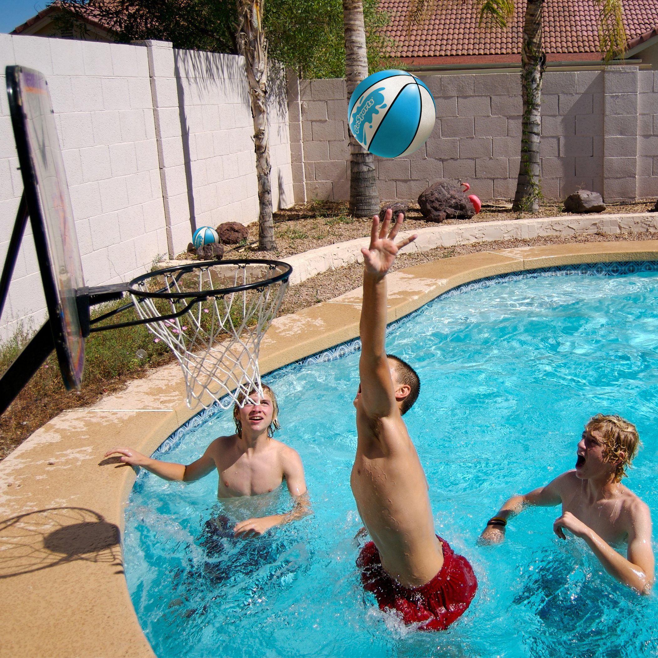 a couple of people playing with a ball in a pool