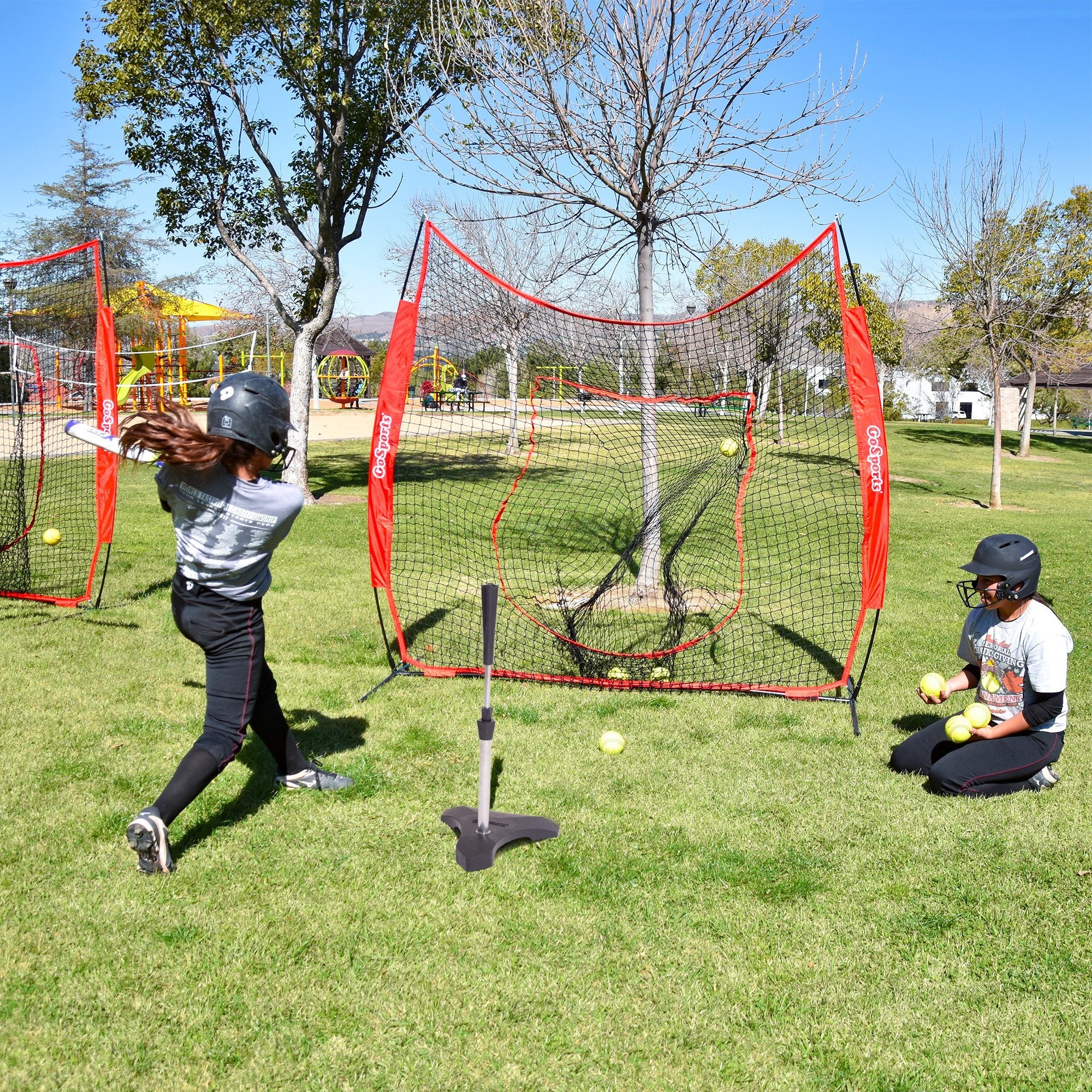 two young boys playing baseball in a field