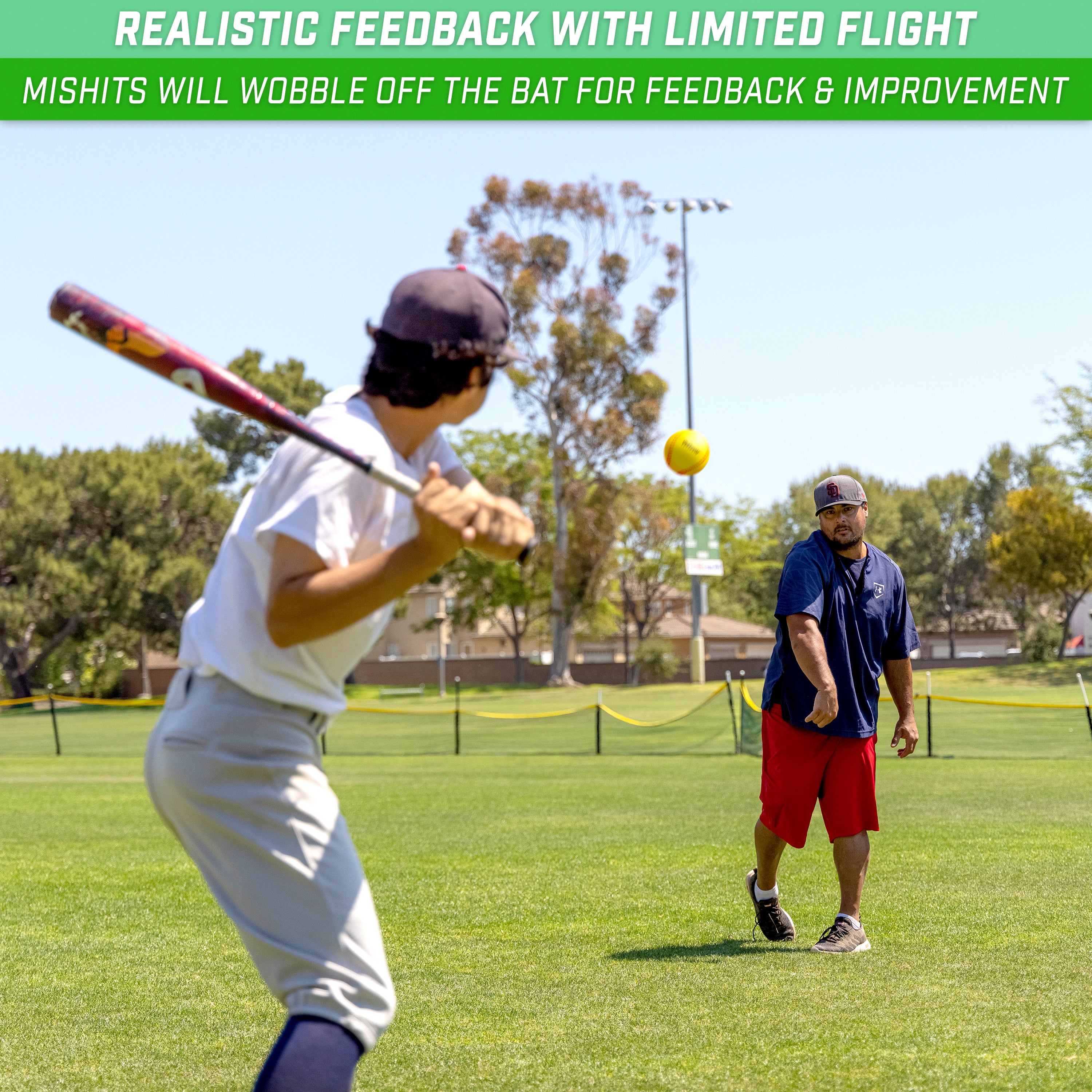 a boy in a baseball uniform swinging a bat