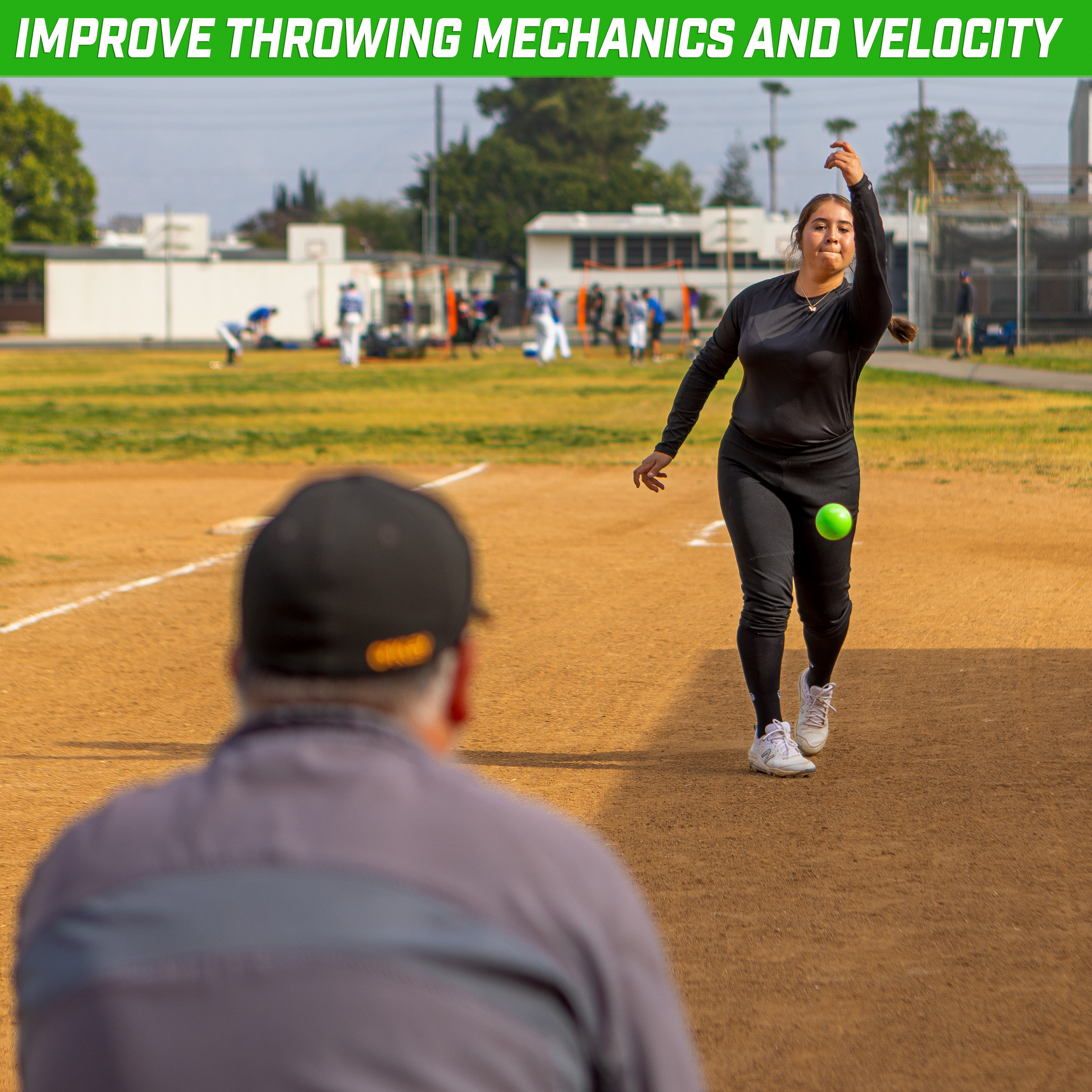 a woman throwing a ball on a baseball field