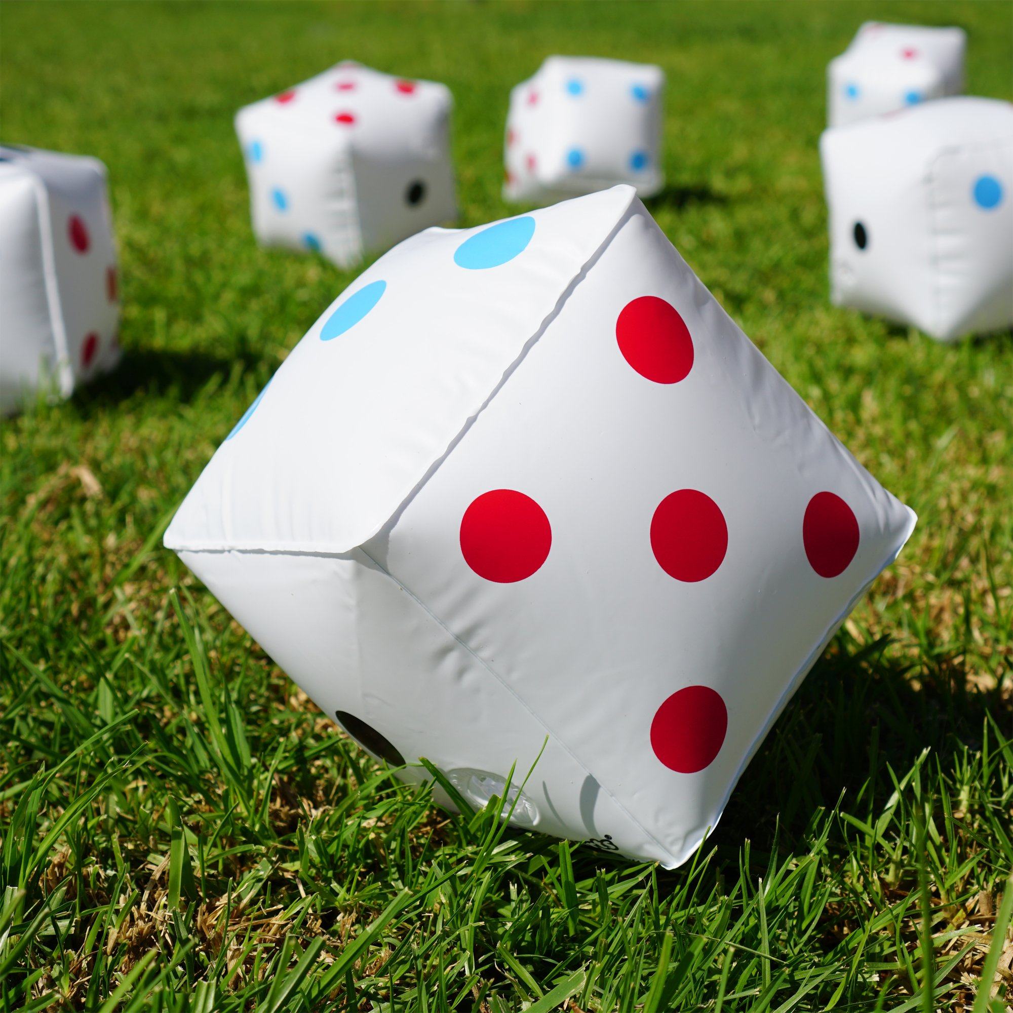 a group of dice sitting on top of a green field