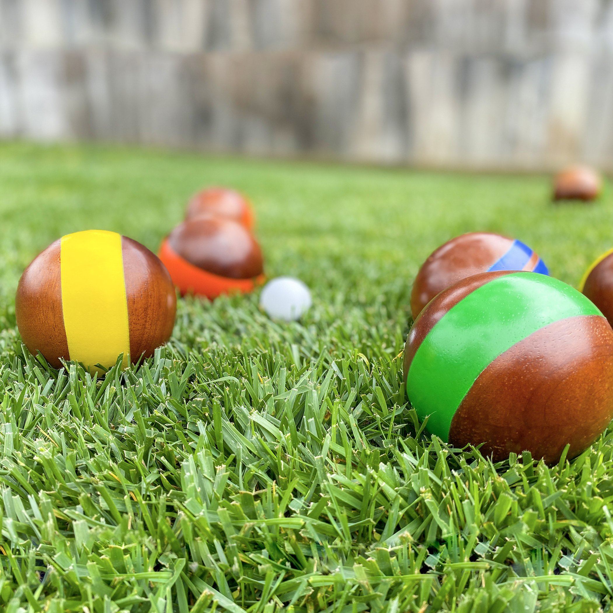 a group of wooden balls on the grass