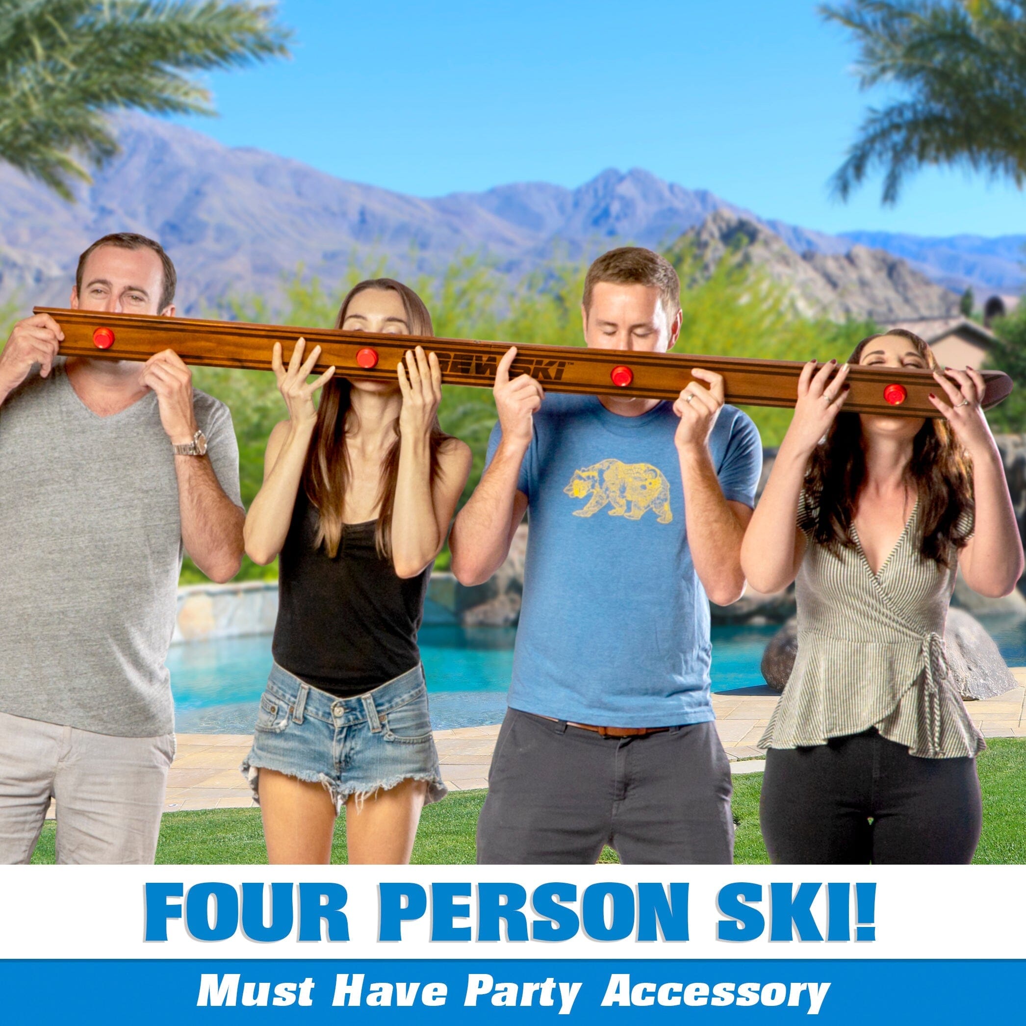 four people holding a surfboard over their heads