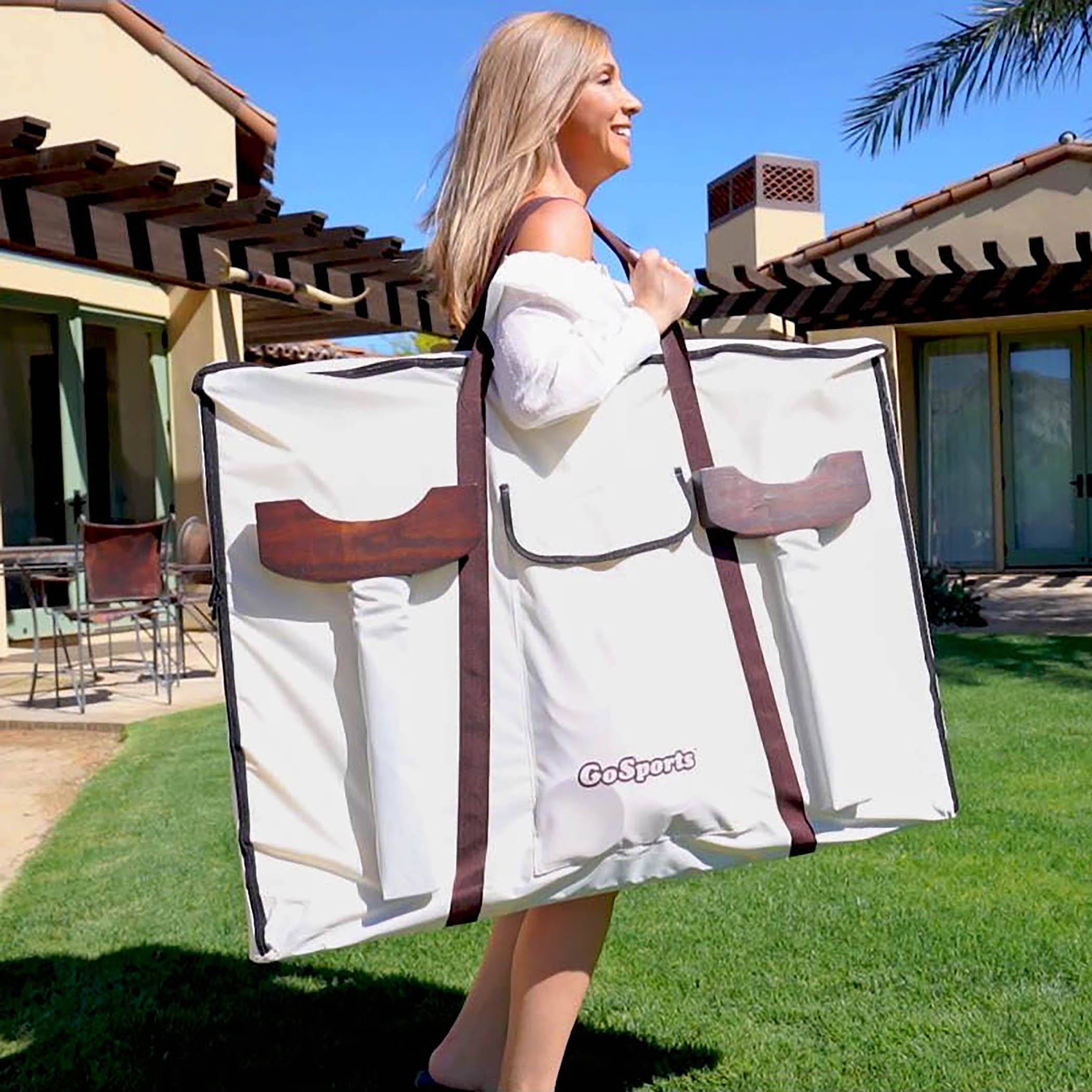 a woman carrying a large white bag