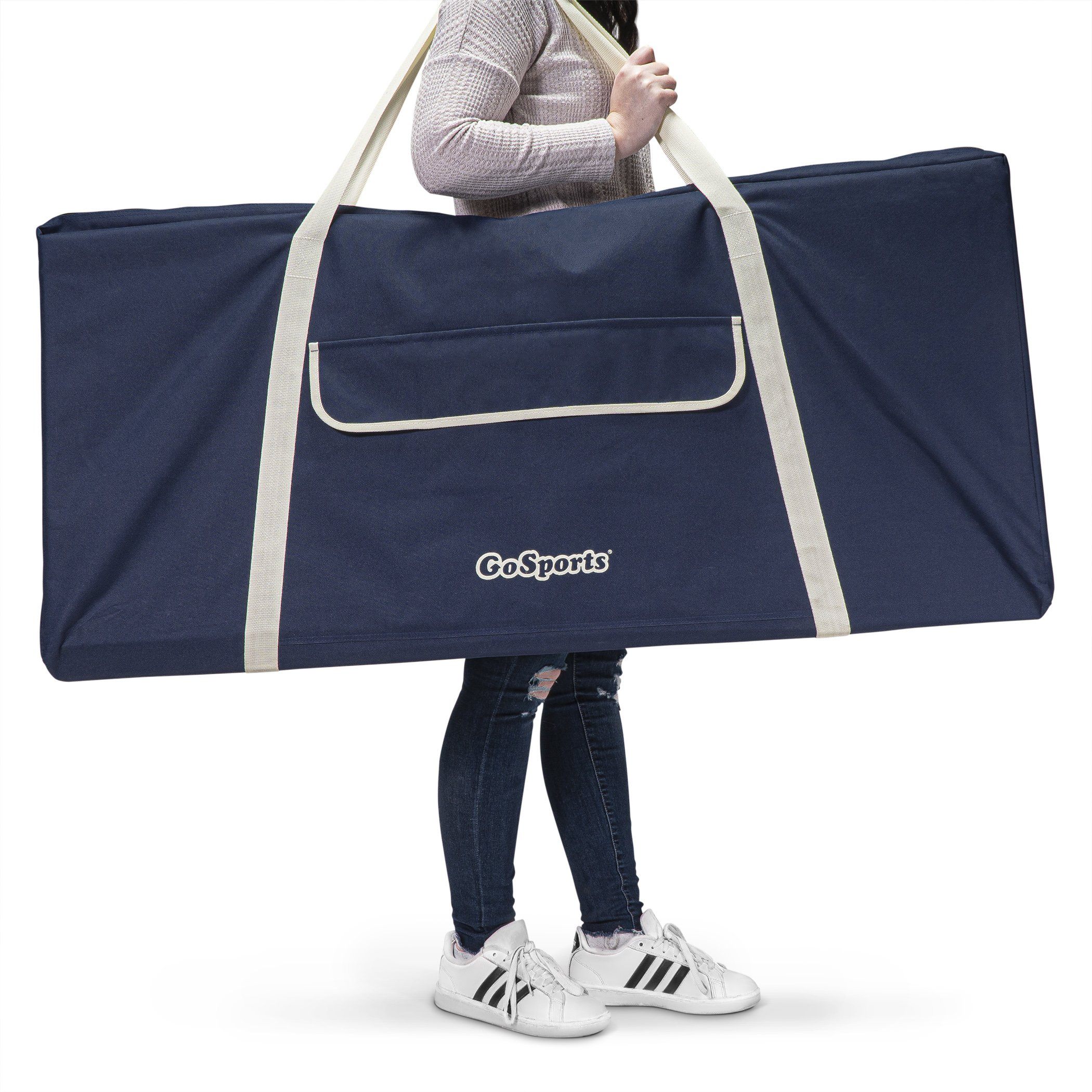 a woman carrying a large duff bag