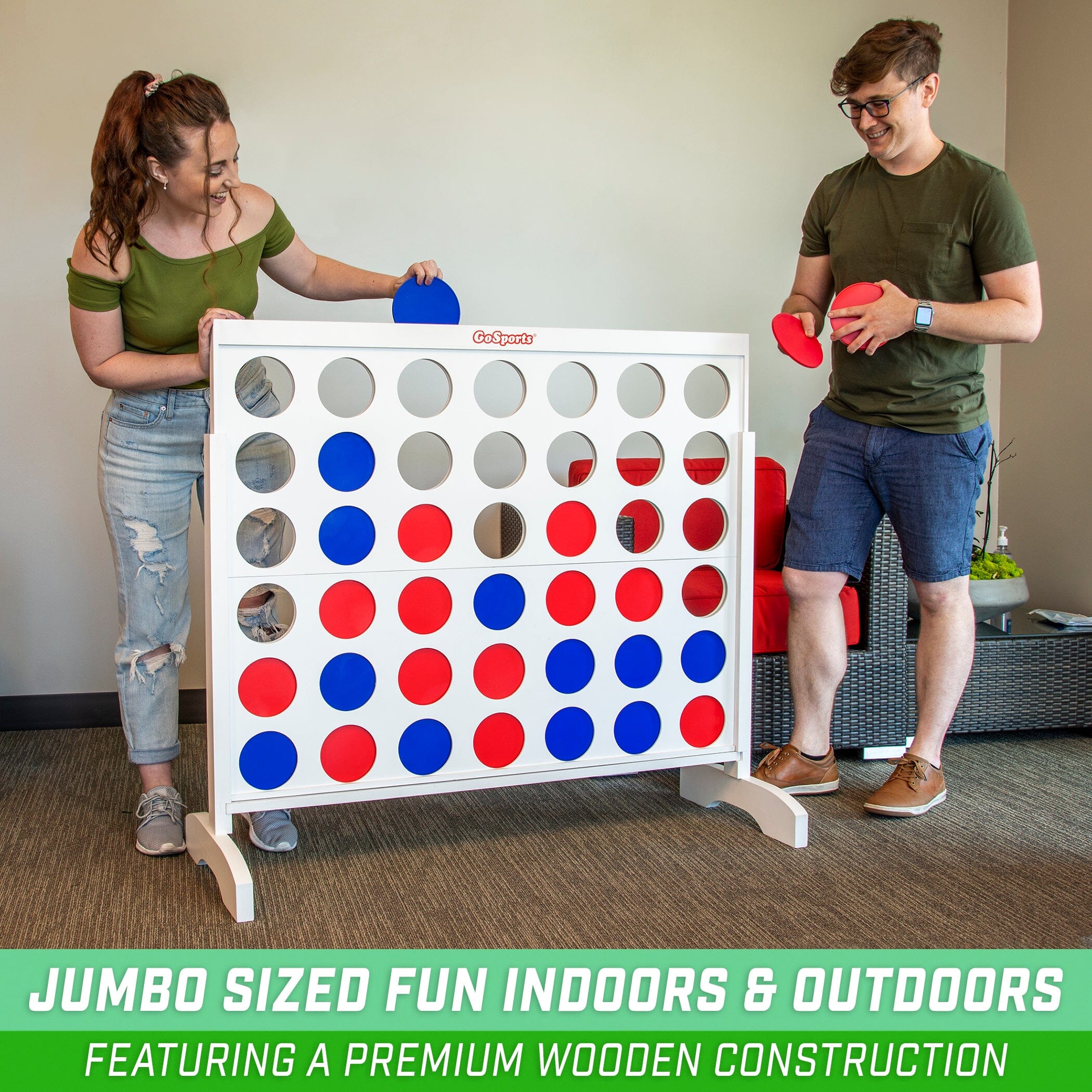 a man and woman playing a game of giant connect