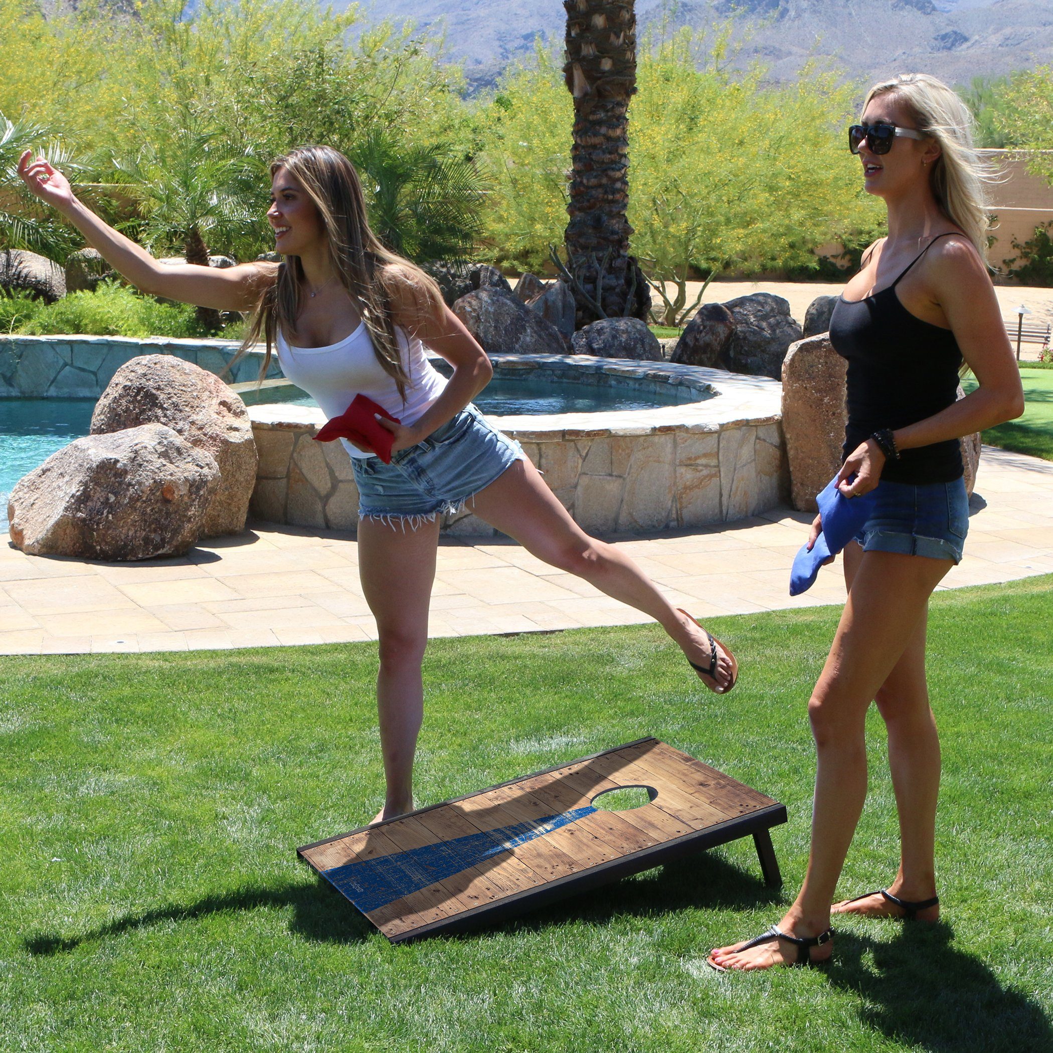 two women playing frcg in the yard