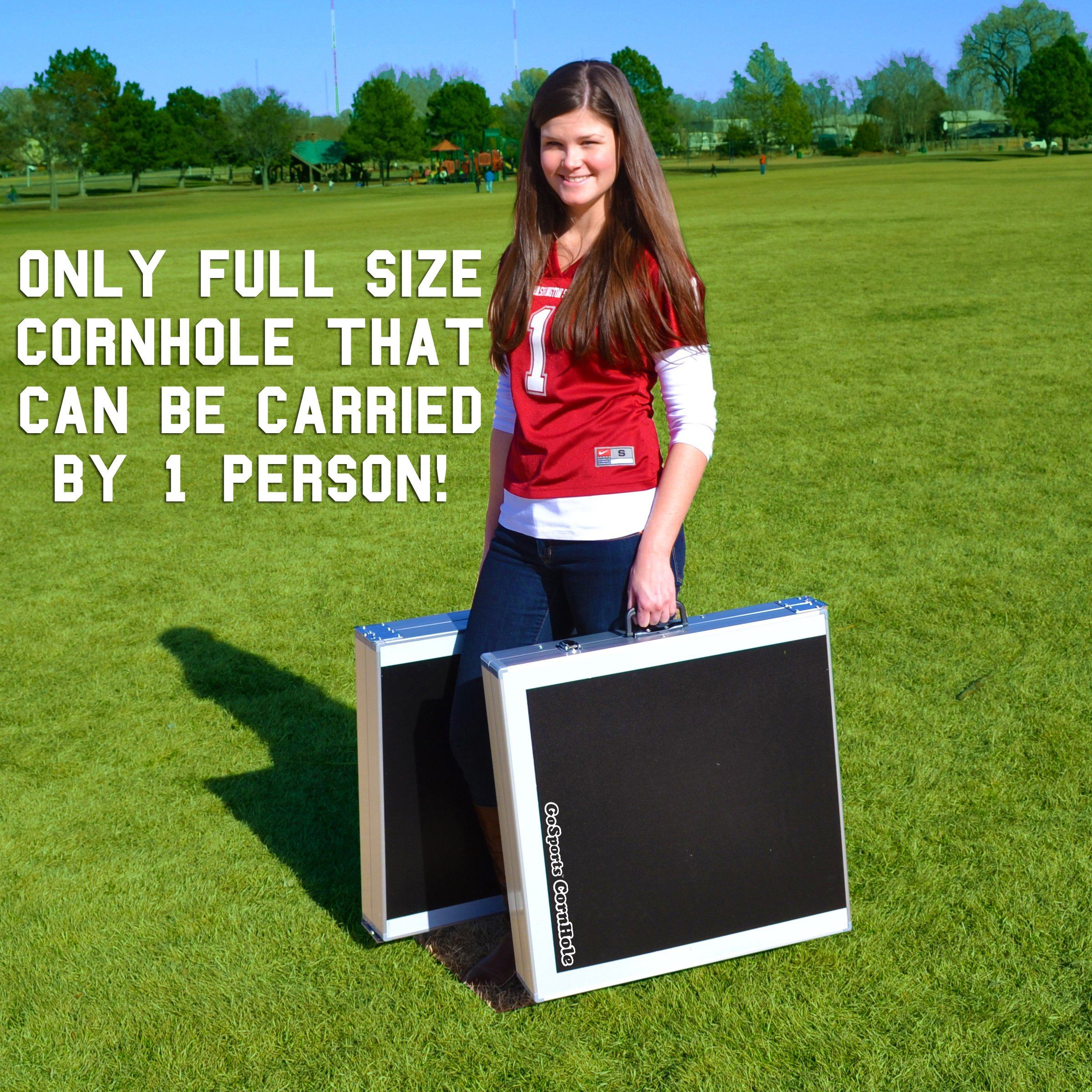 a girl holding a suitcase with a sign on it