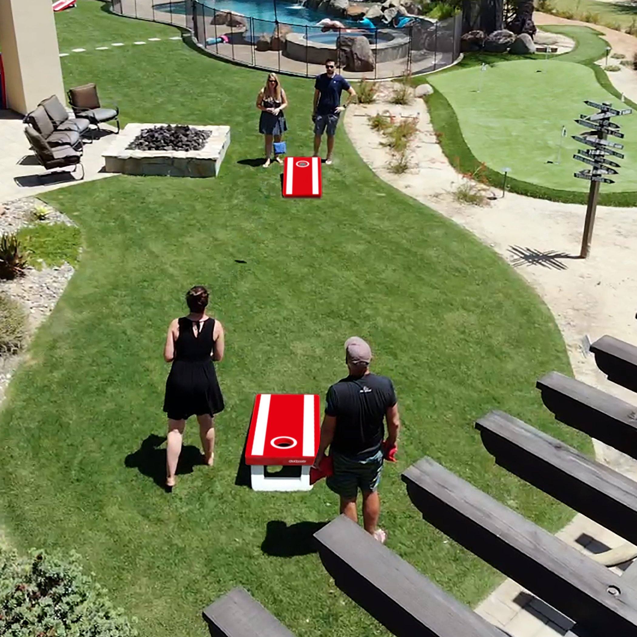 a man and woman playing frosh game in the backyard