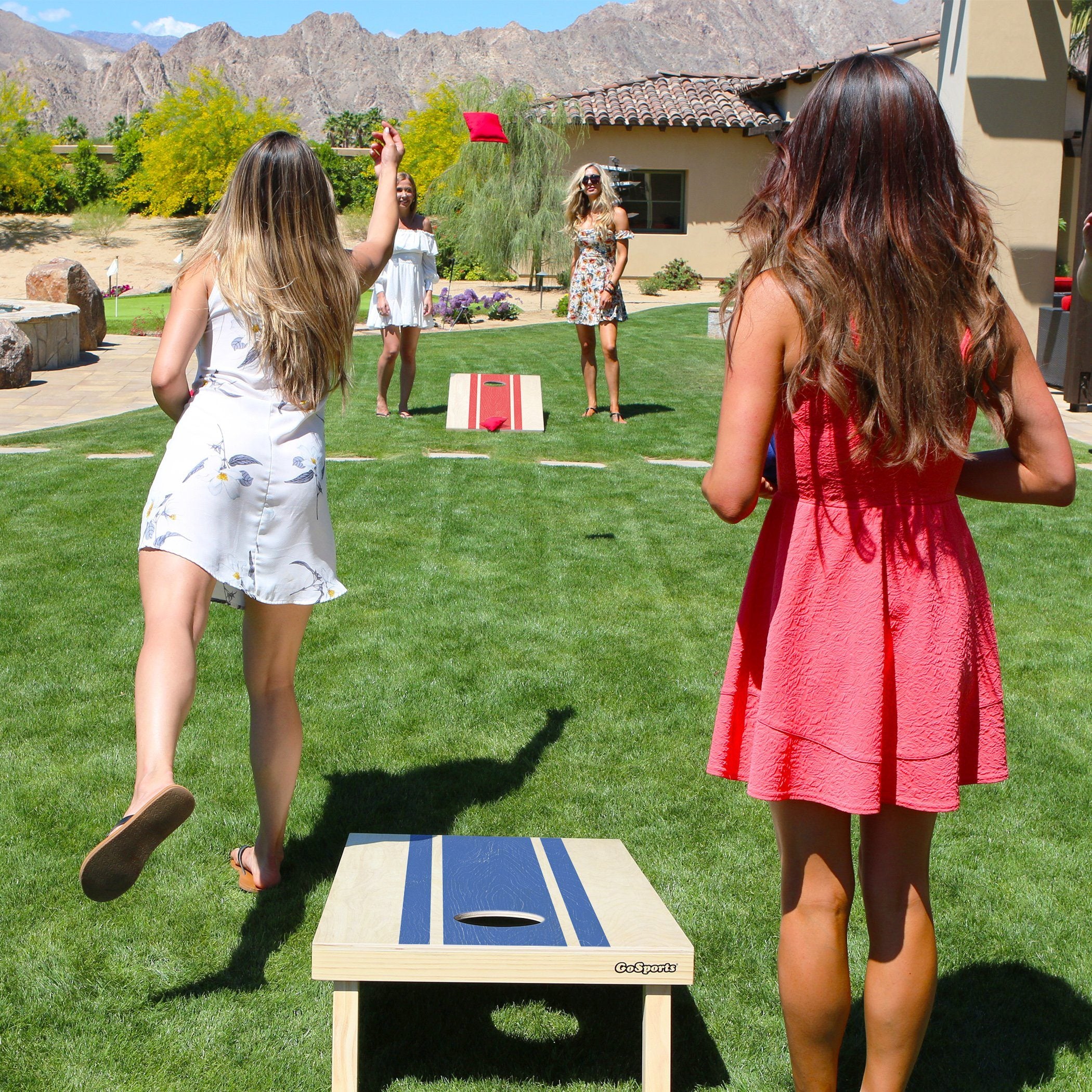 two girls playing a game of corn corn