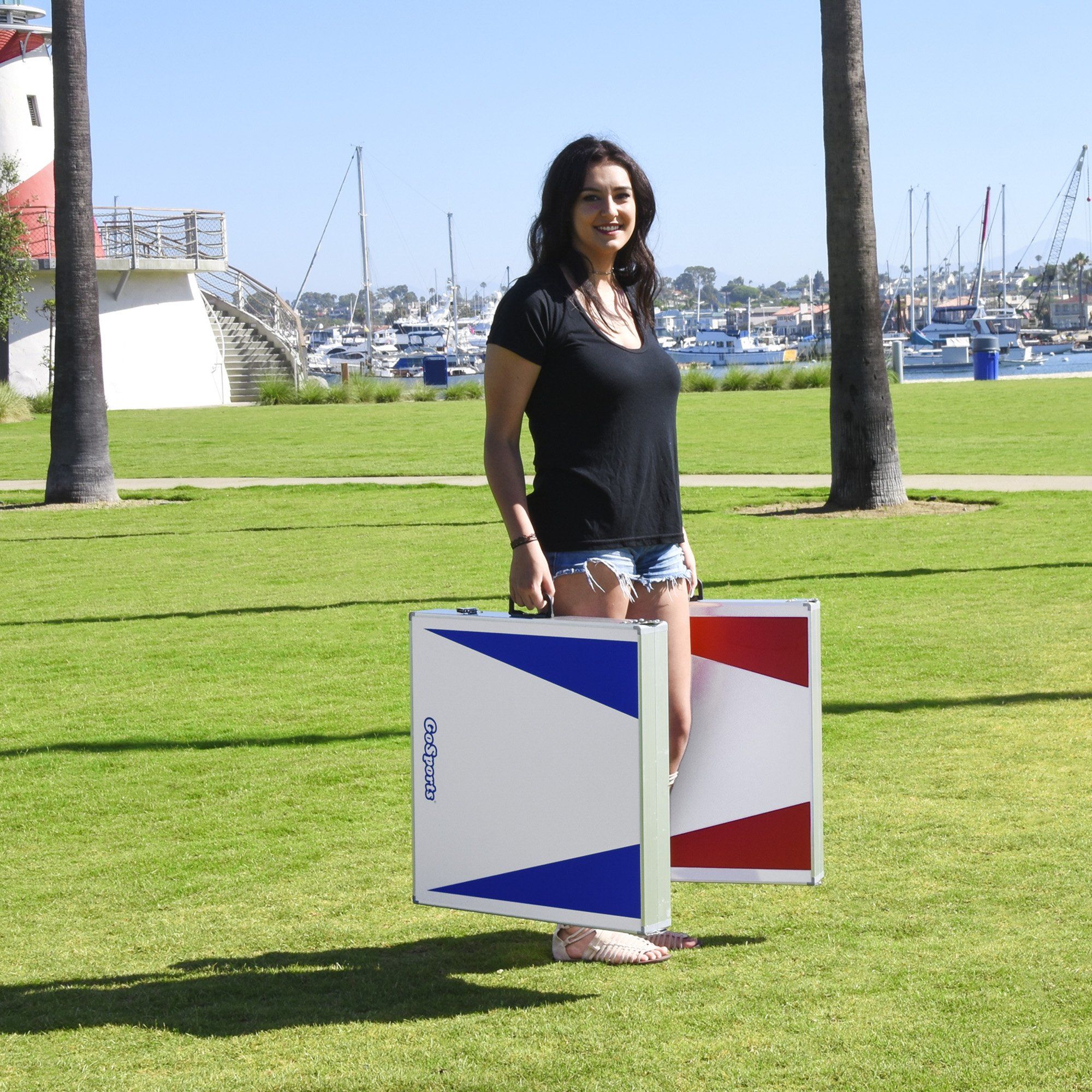 a woman standing in a field with a box