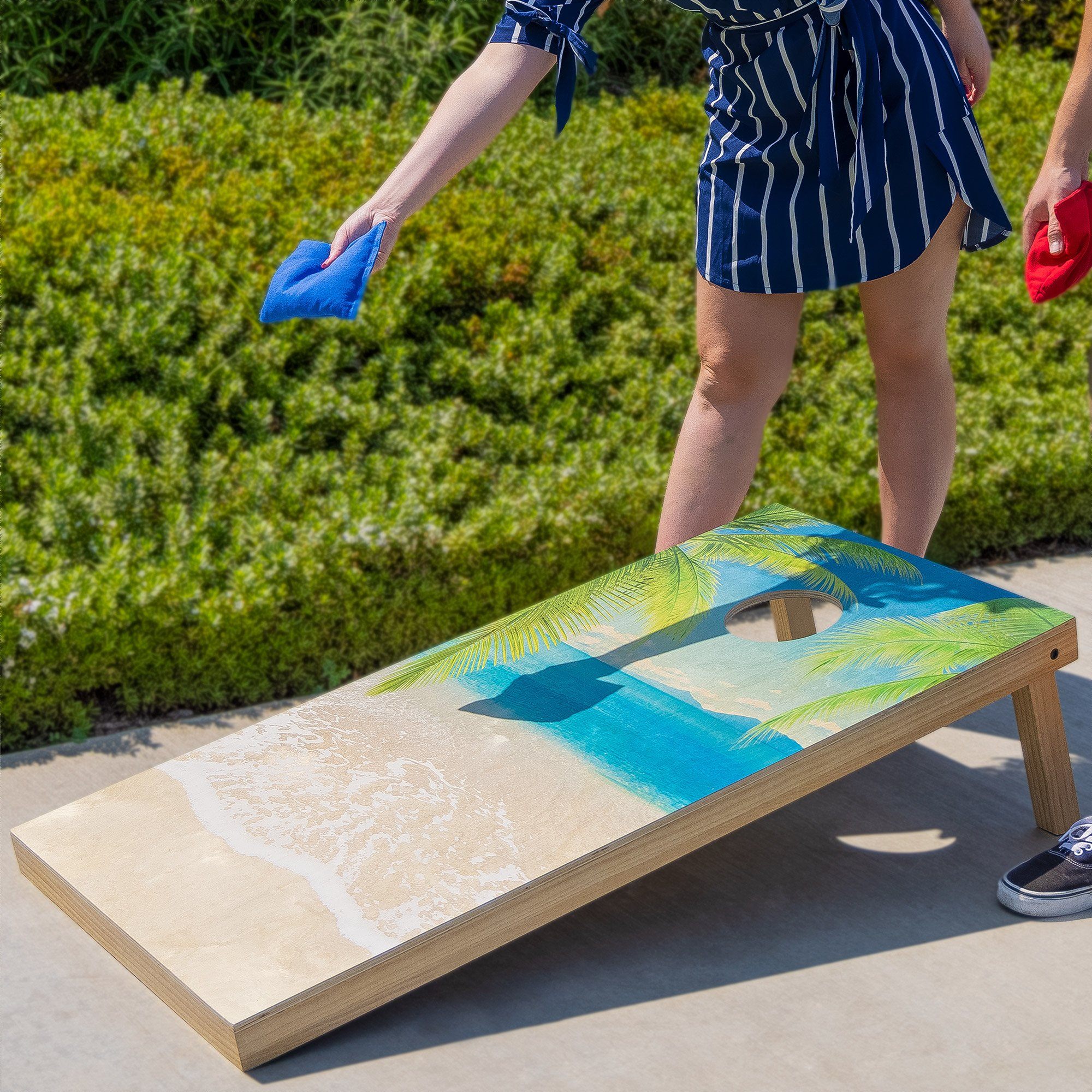 a woman in a blue shirt and shorts is on a skateboard
