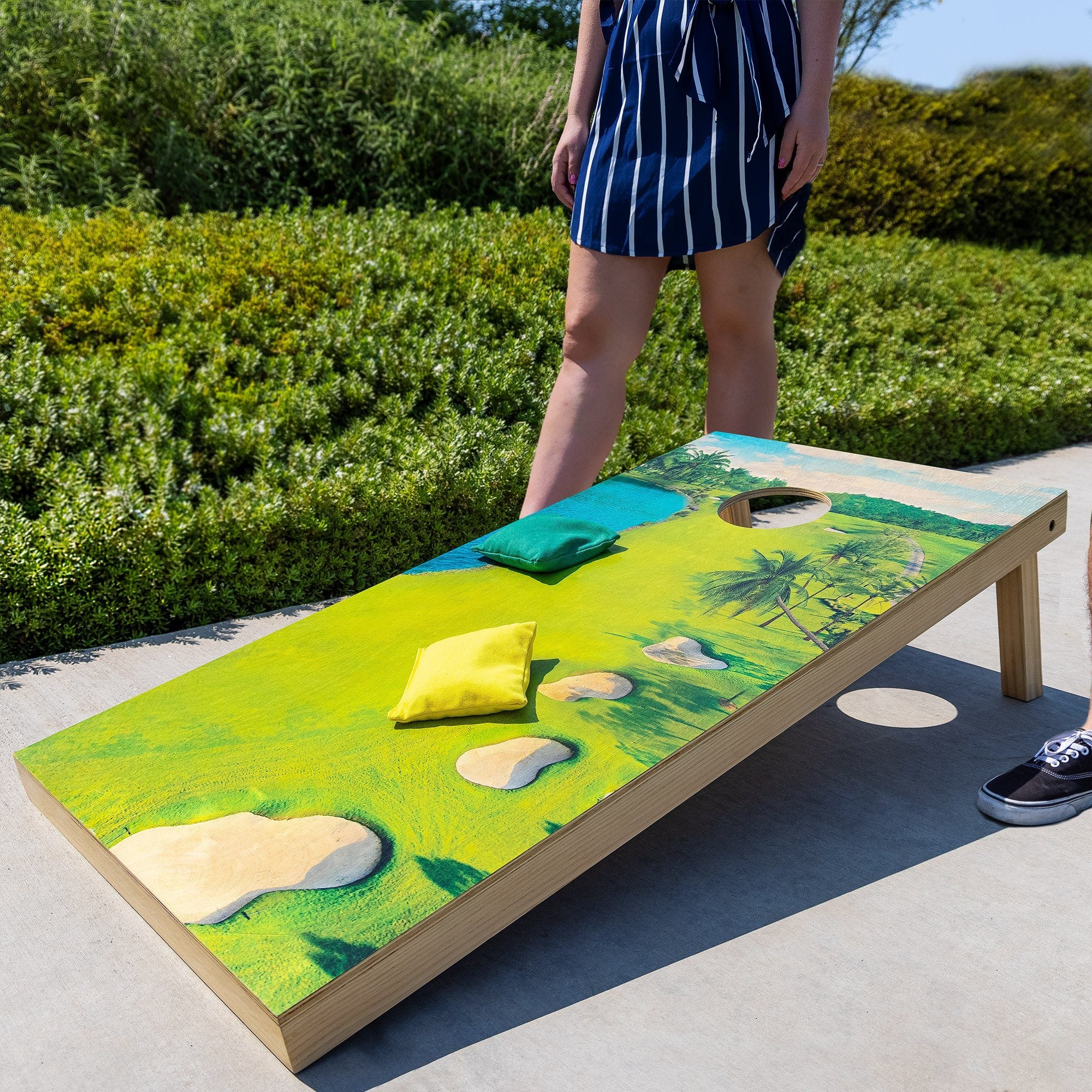 a person standing on a wooden bench with a painting on it