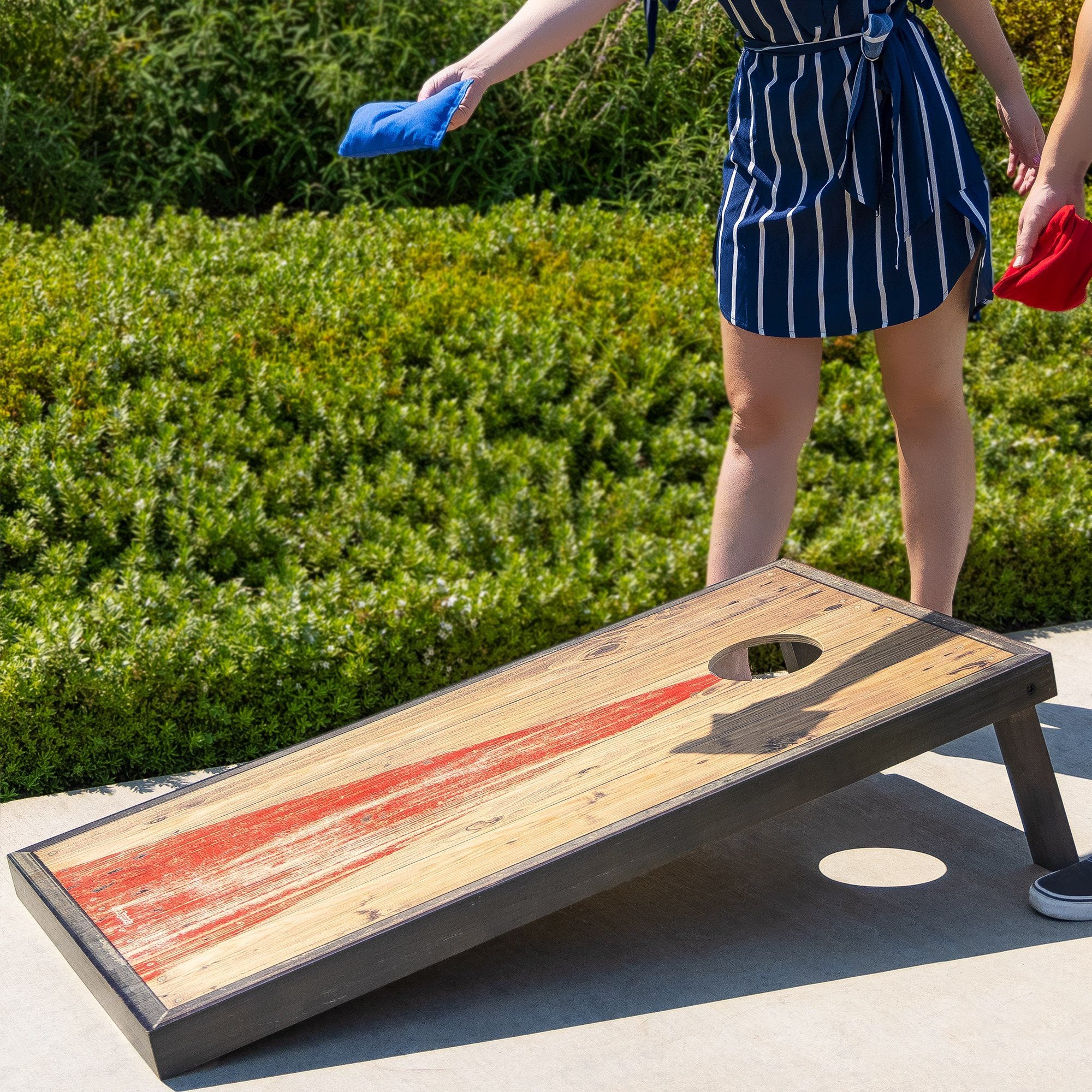 a woman in a blue and white striped dress playing a game