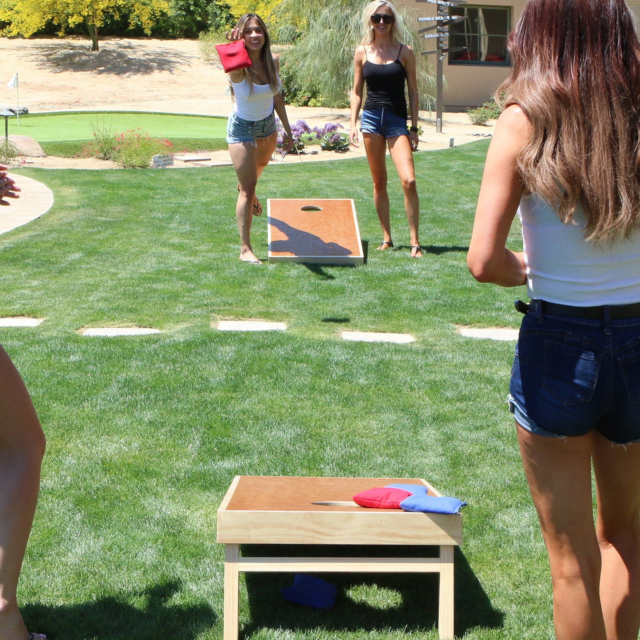 a group of women playing corn corn games