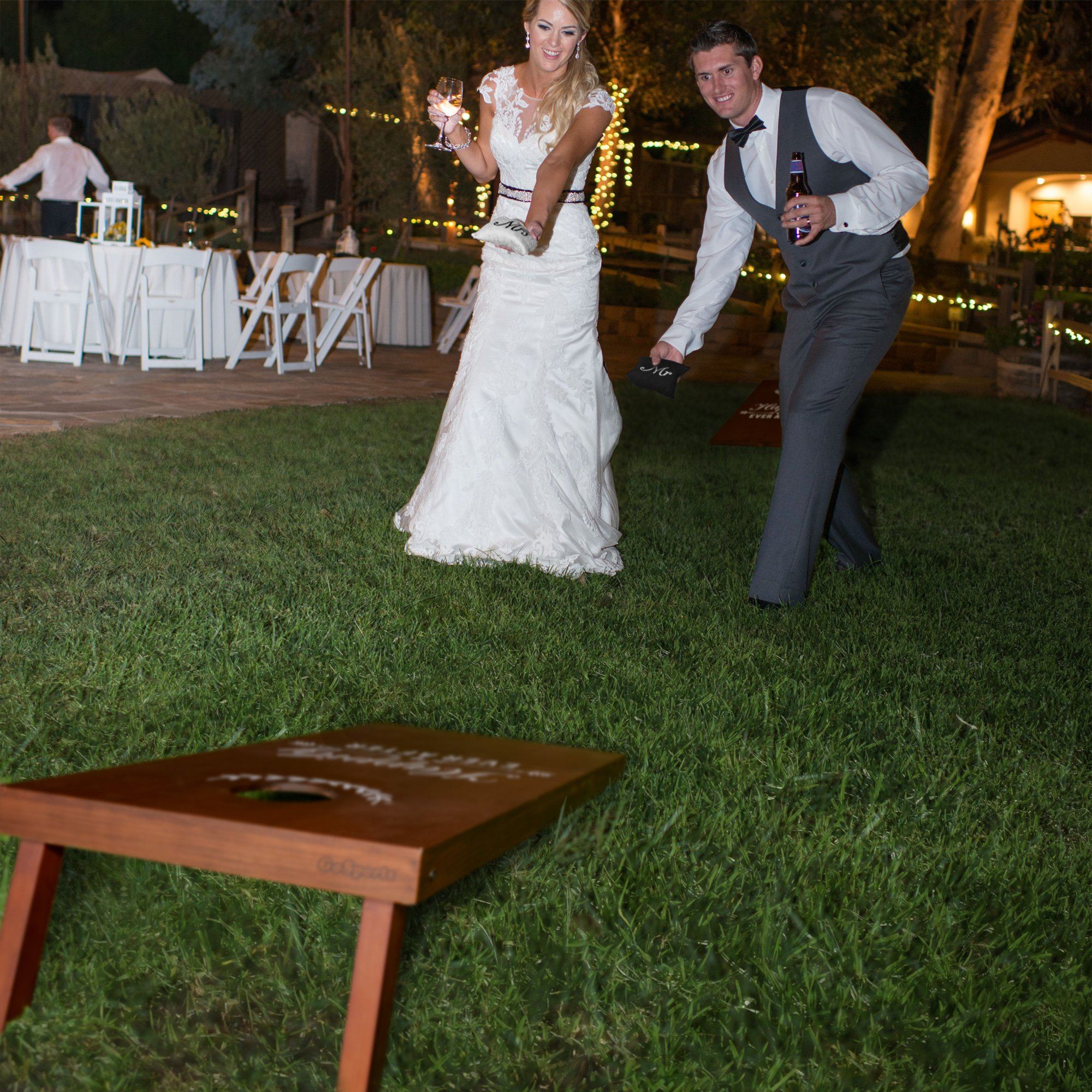 a bride and groom are dancing in the grass