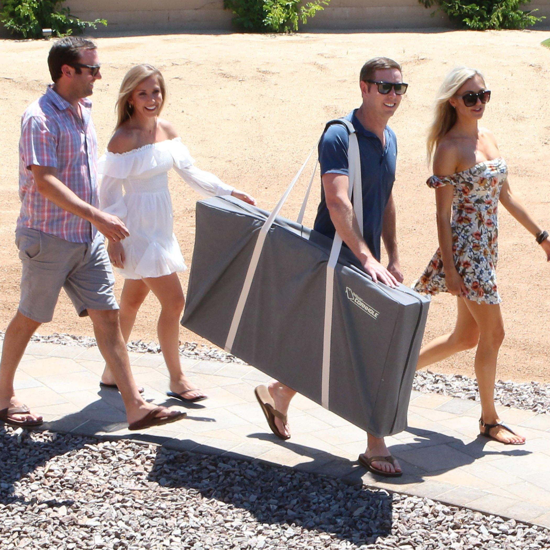 the couple are walking down the street carrying their luggage