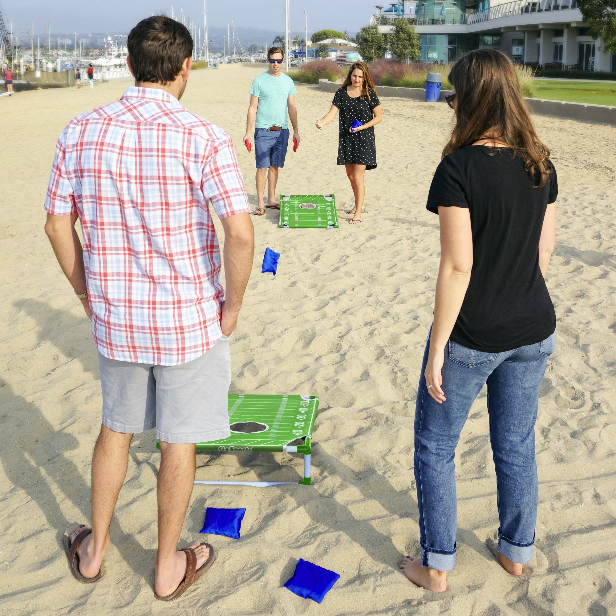 a group of people playing a game on the beach