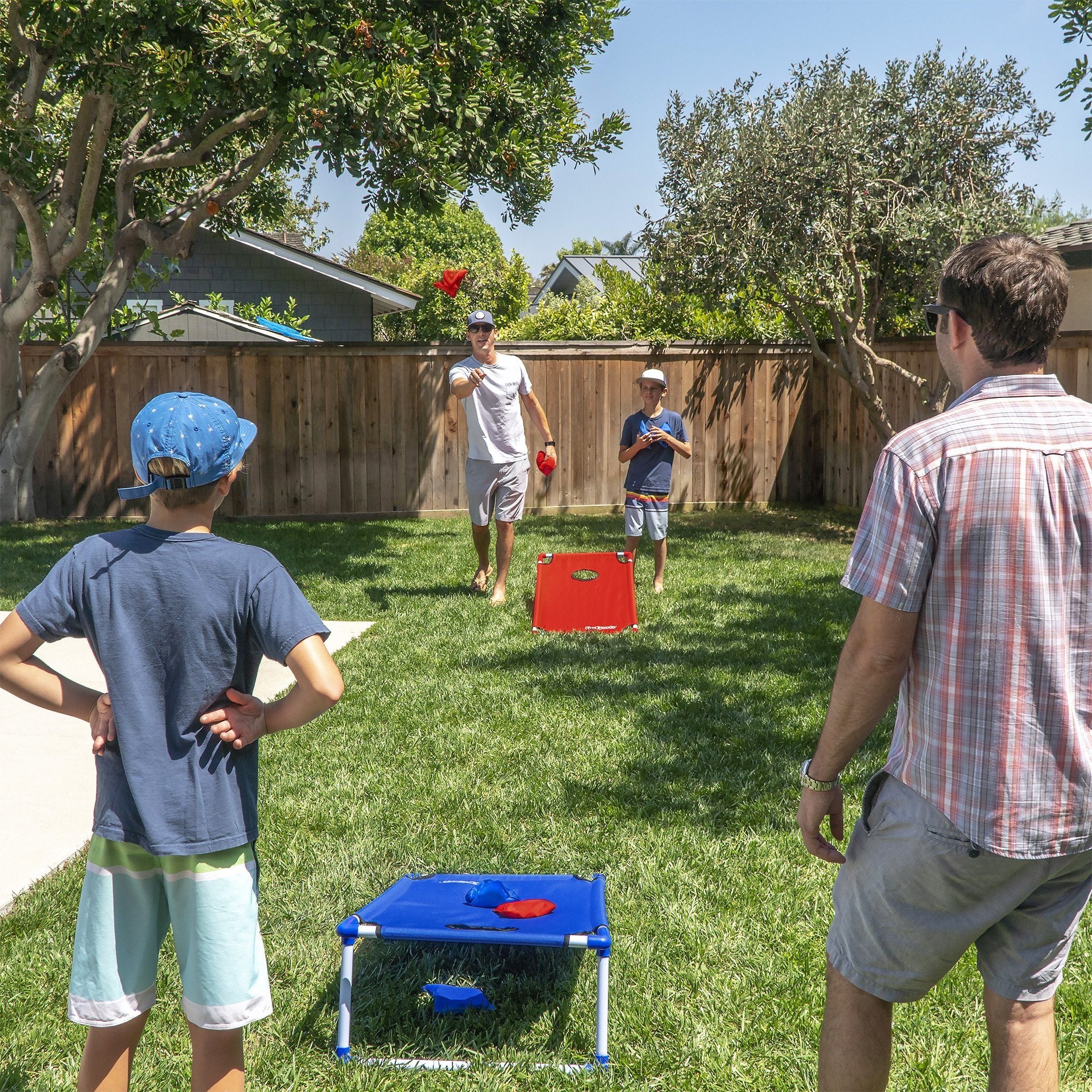 a group of people playing a game in the backyard